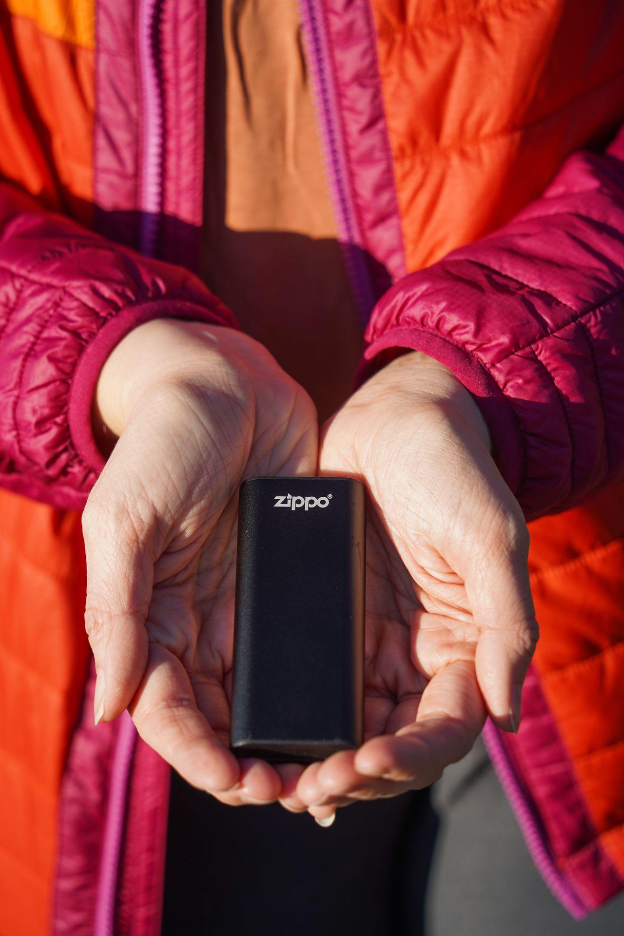 Holding the Zippo Handwarmer with both hands.