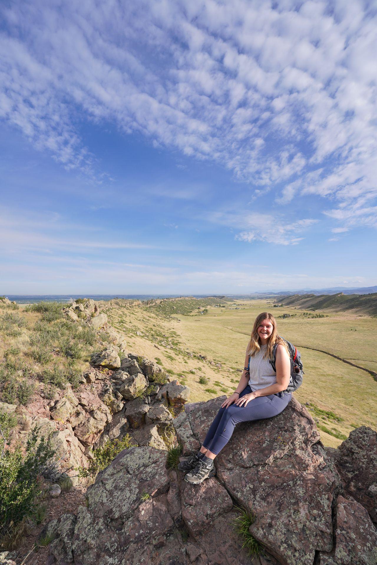 Lydia wearing blue leggings on a trail in Colorado