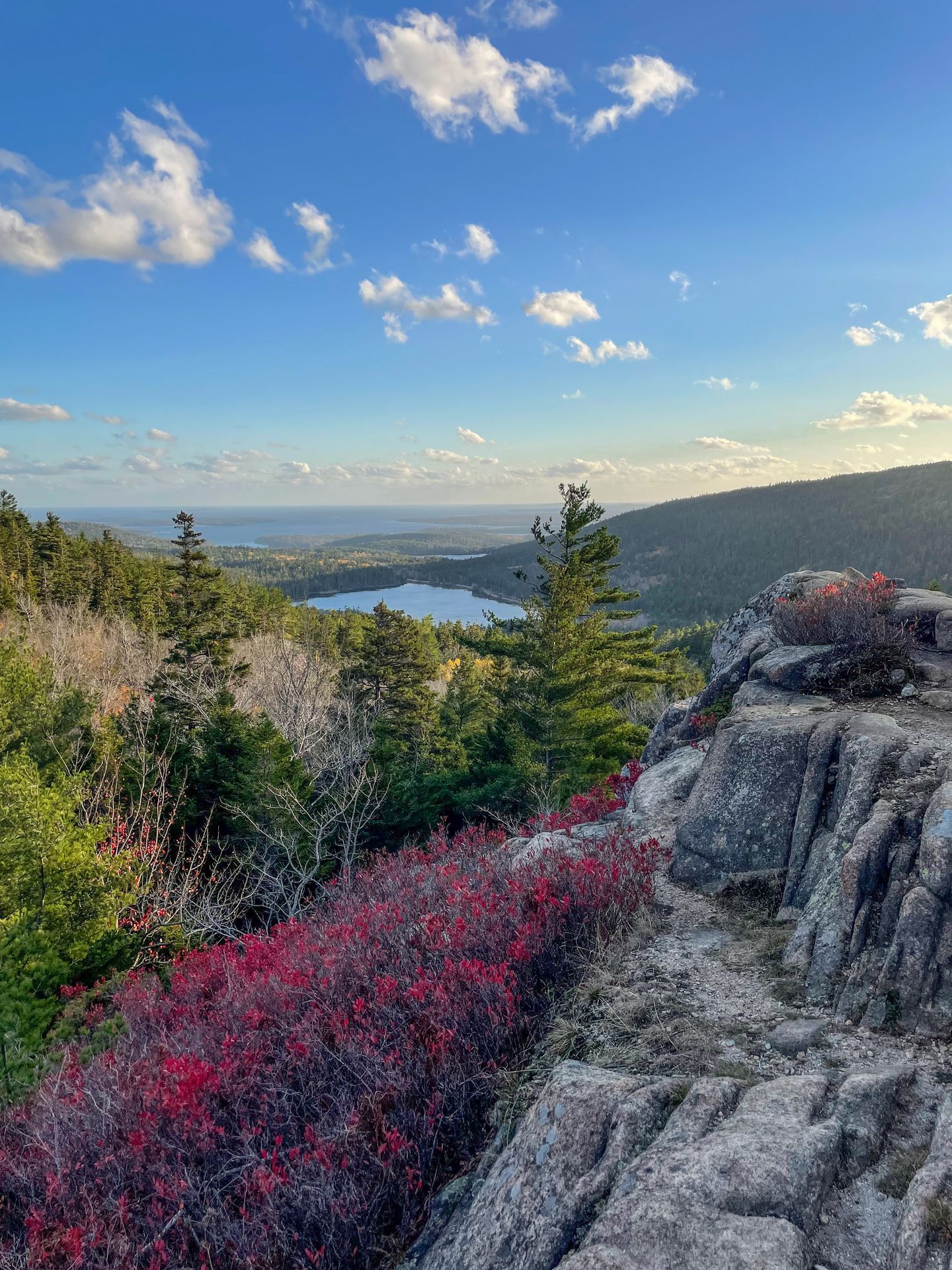 A mountain with a lake in the distance seen from the Parkman Mountain Loop