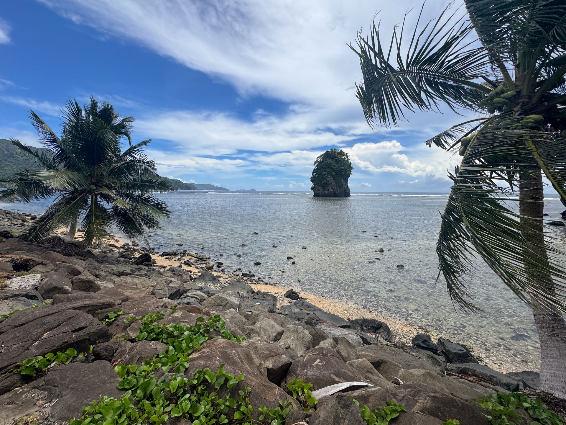 Looking from a beach to a small island out in the water