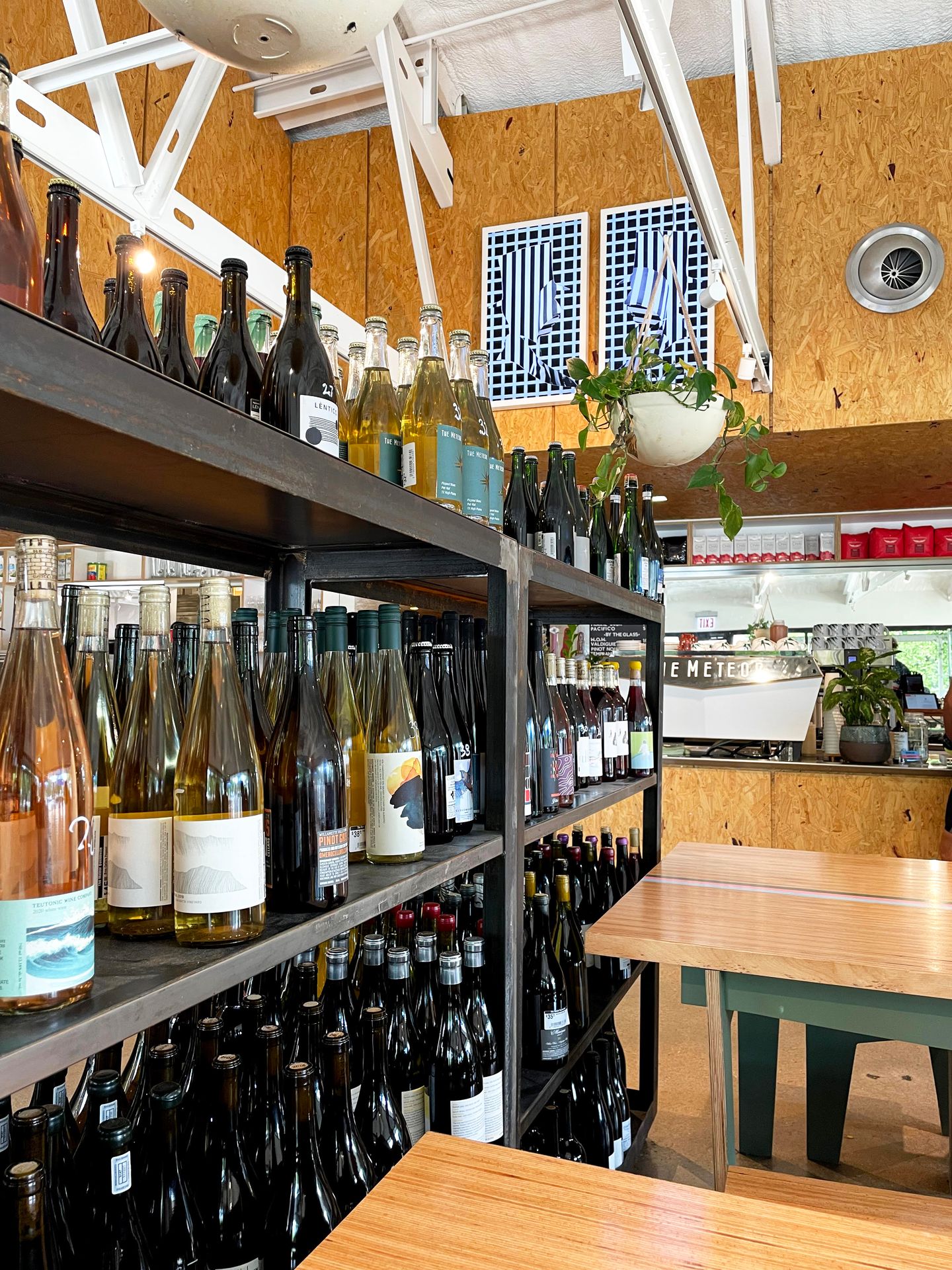A shelf full of wine bottles inside The Meteor cafe and bar.