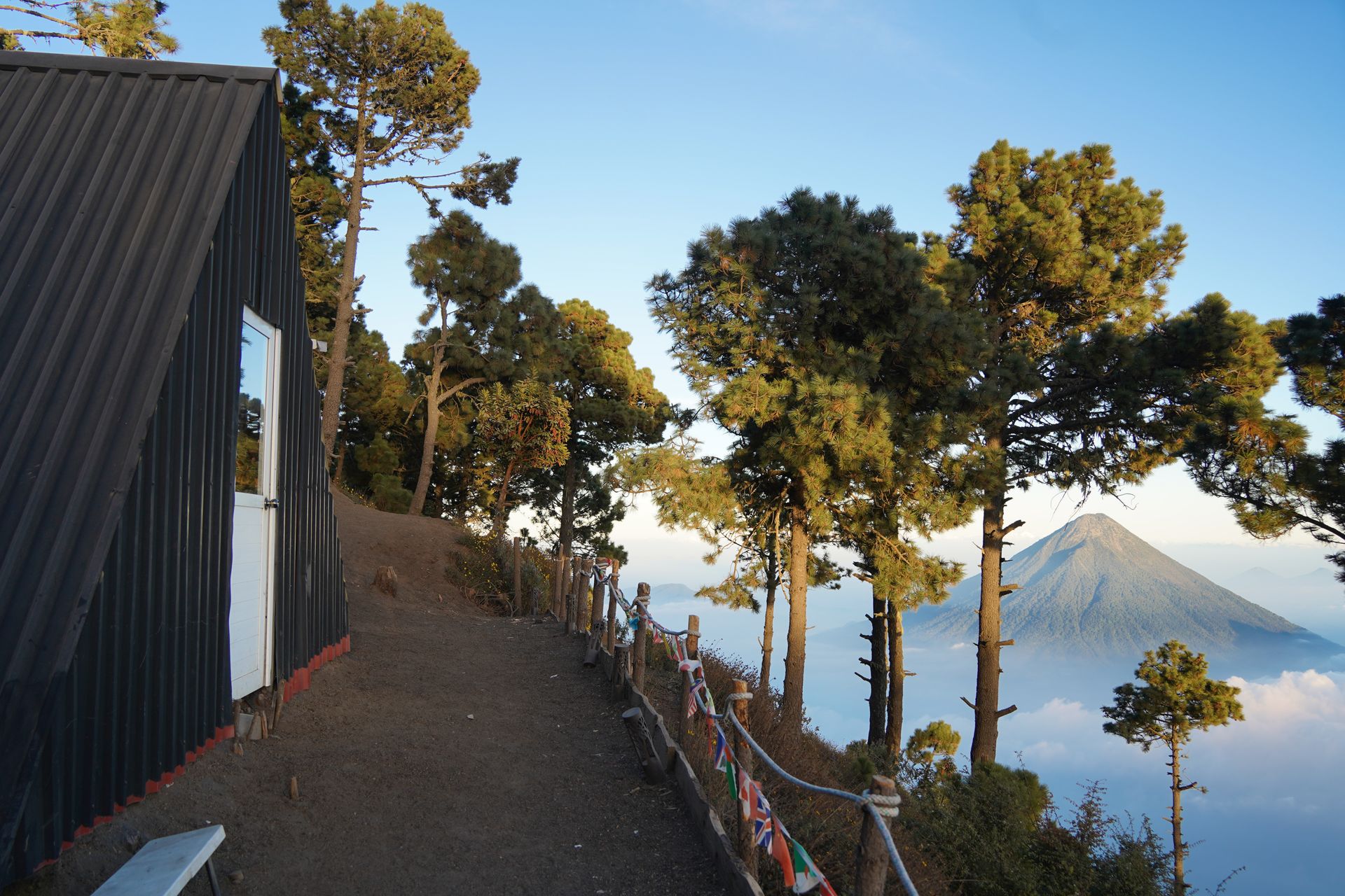 An A-frame building with a view of a volcano at the Wicho & Charlie's camp on Acatenango