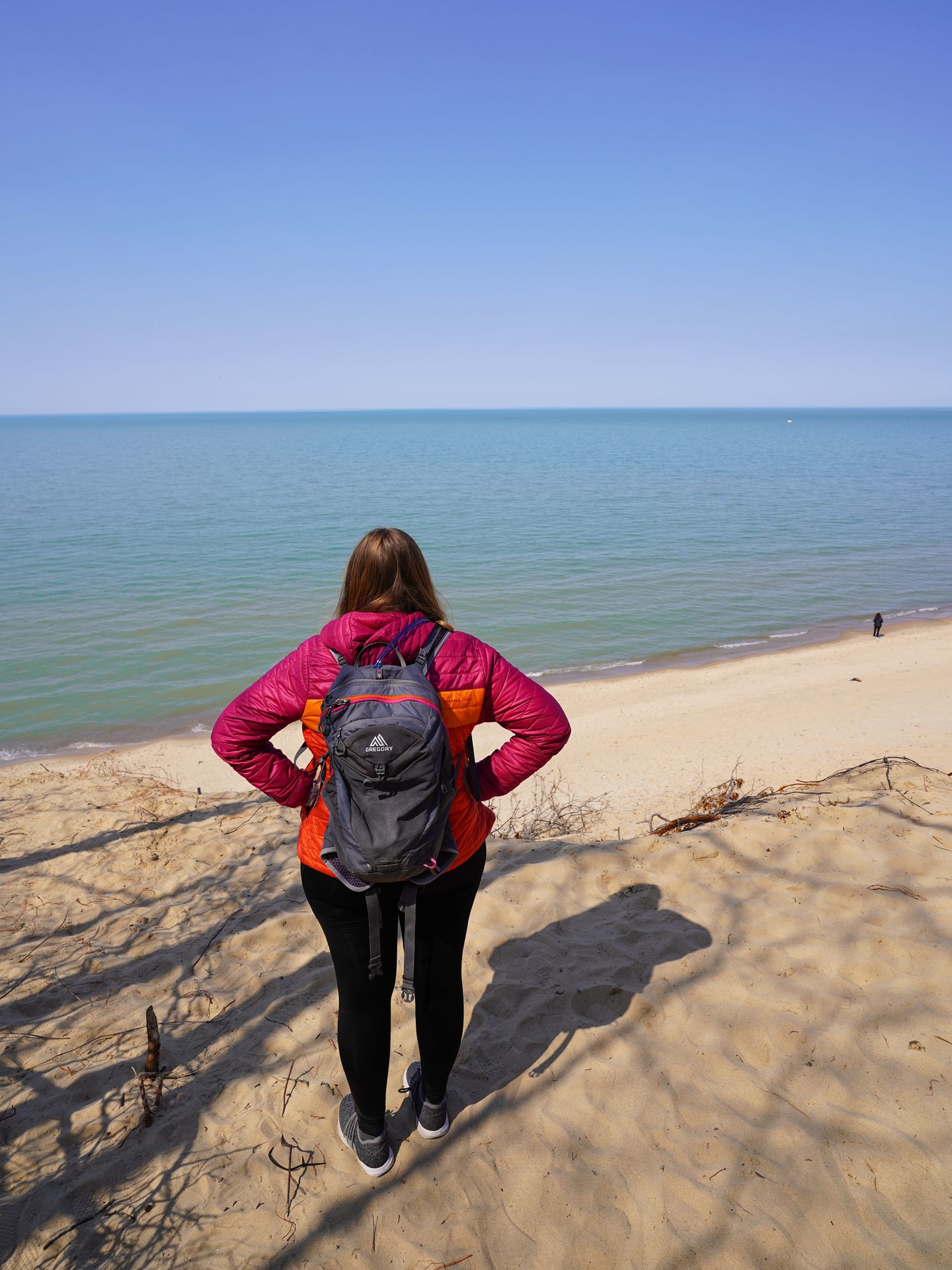 Lydia standing on a sand dune and looking out at Lake Michigan from the Mount Baldy Beach Trail