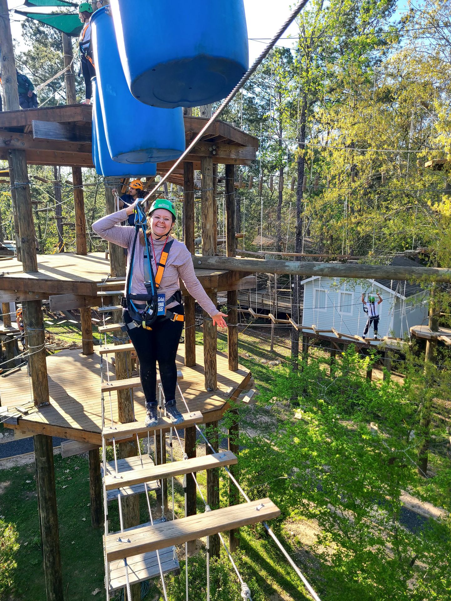 Lydia crossing over pieces of wood at Texas Treeventures