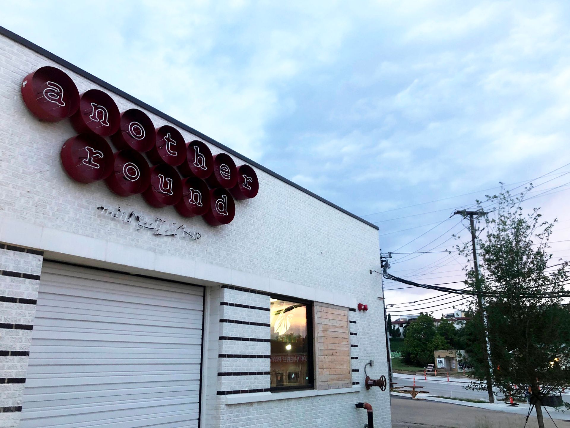 A white building with the words "Another Round" at the top.