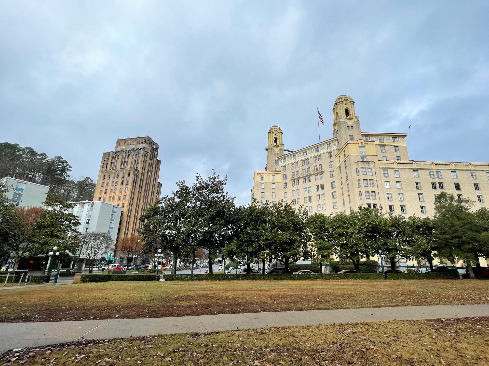 A view of the Arlington Hotel from across the street. The hotel is several stories tall with two towers on each side.