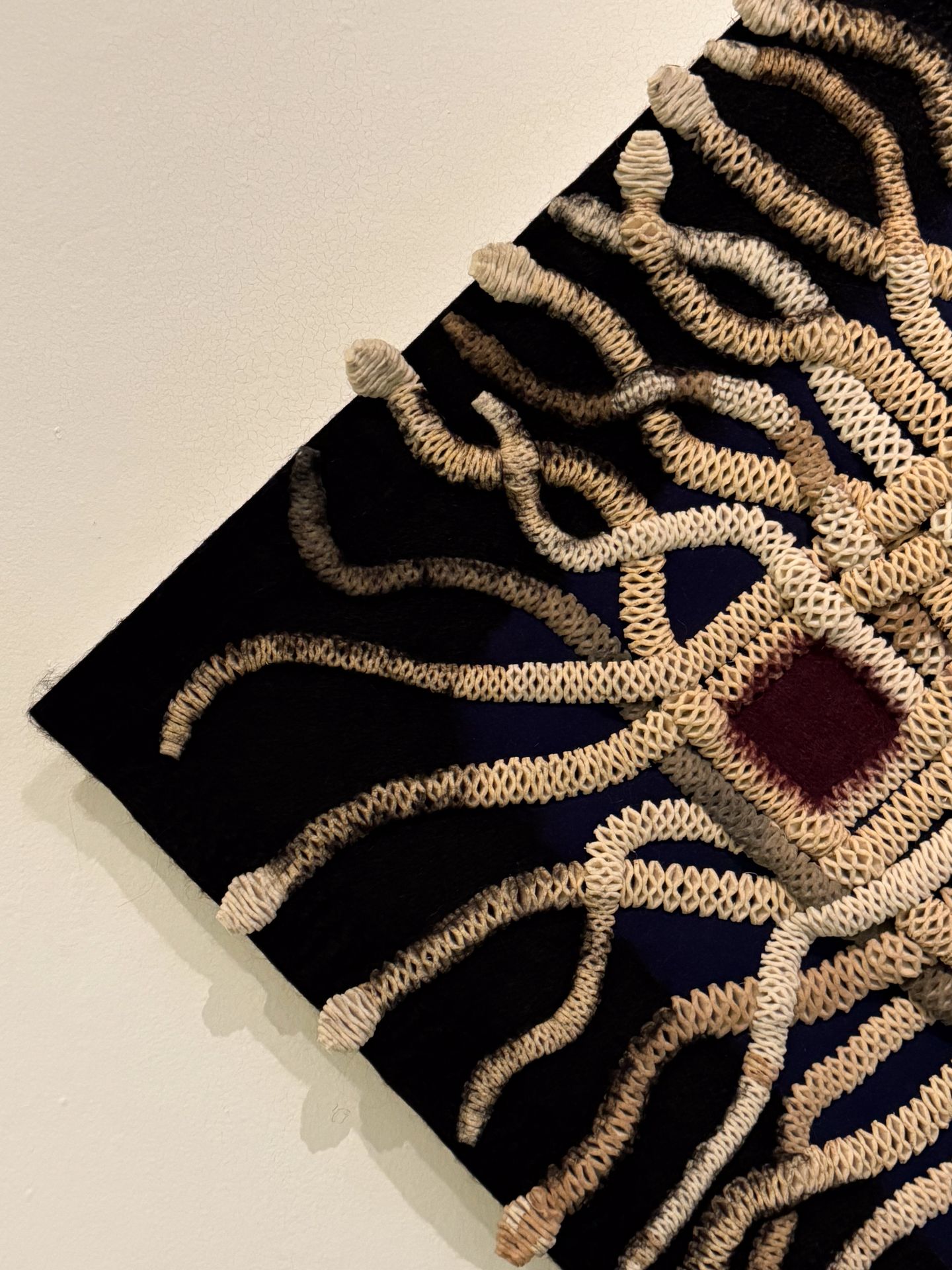 A close up look at a large piece of textile art in the Museo Textil de Oaxaca