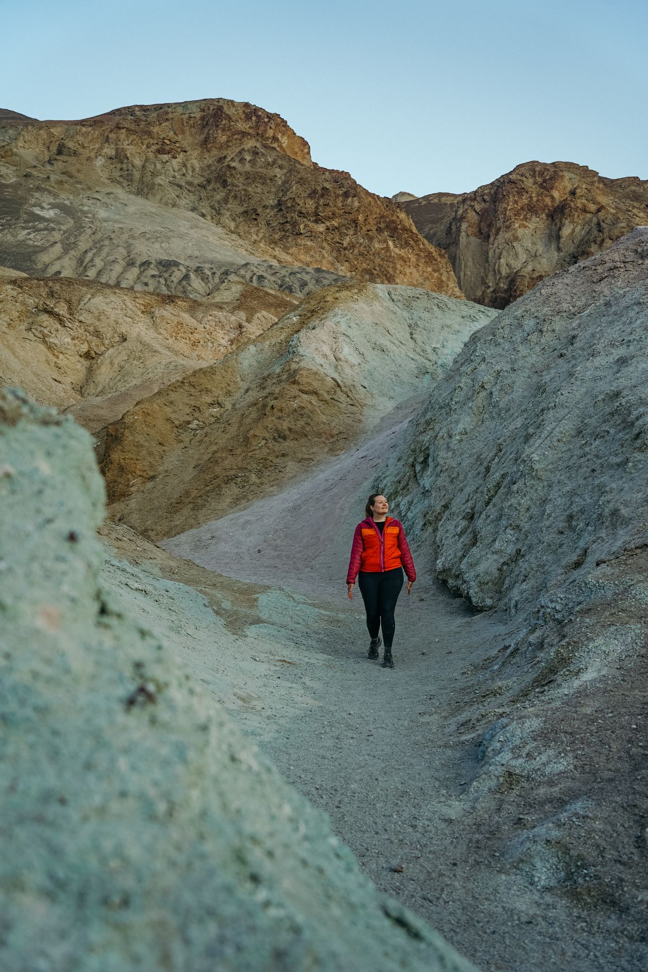 Lydia walking next to rocks with a blueish color at Artist's Palette
