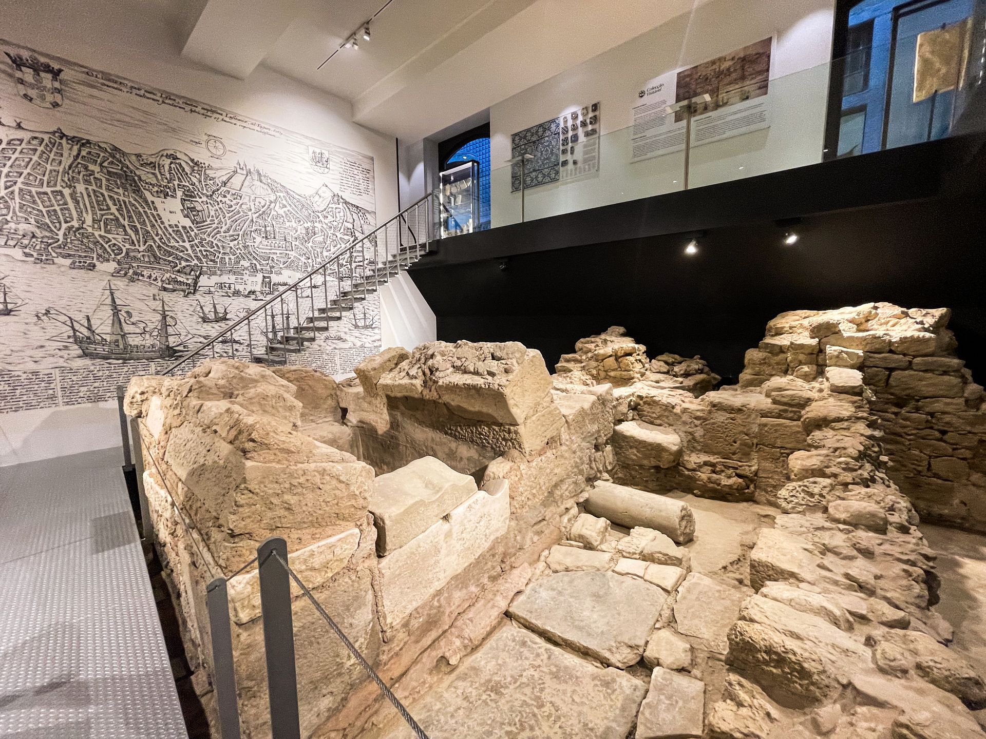 A room with Roman ruins inside of the Aurea Museum Hotel