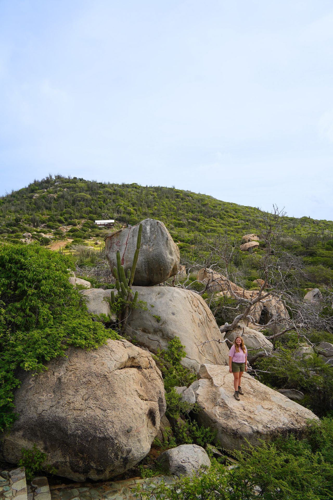 Lydia standing on a giant boulder at the Ayo Rock Formations