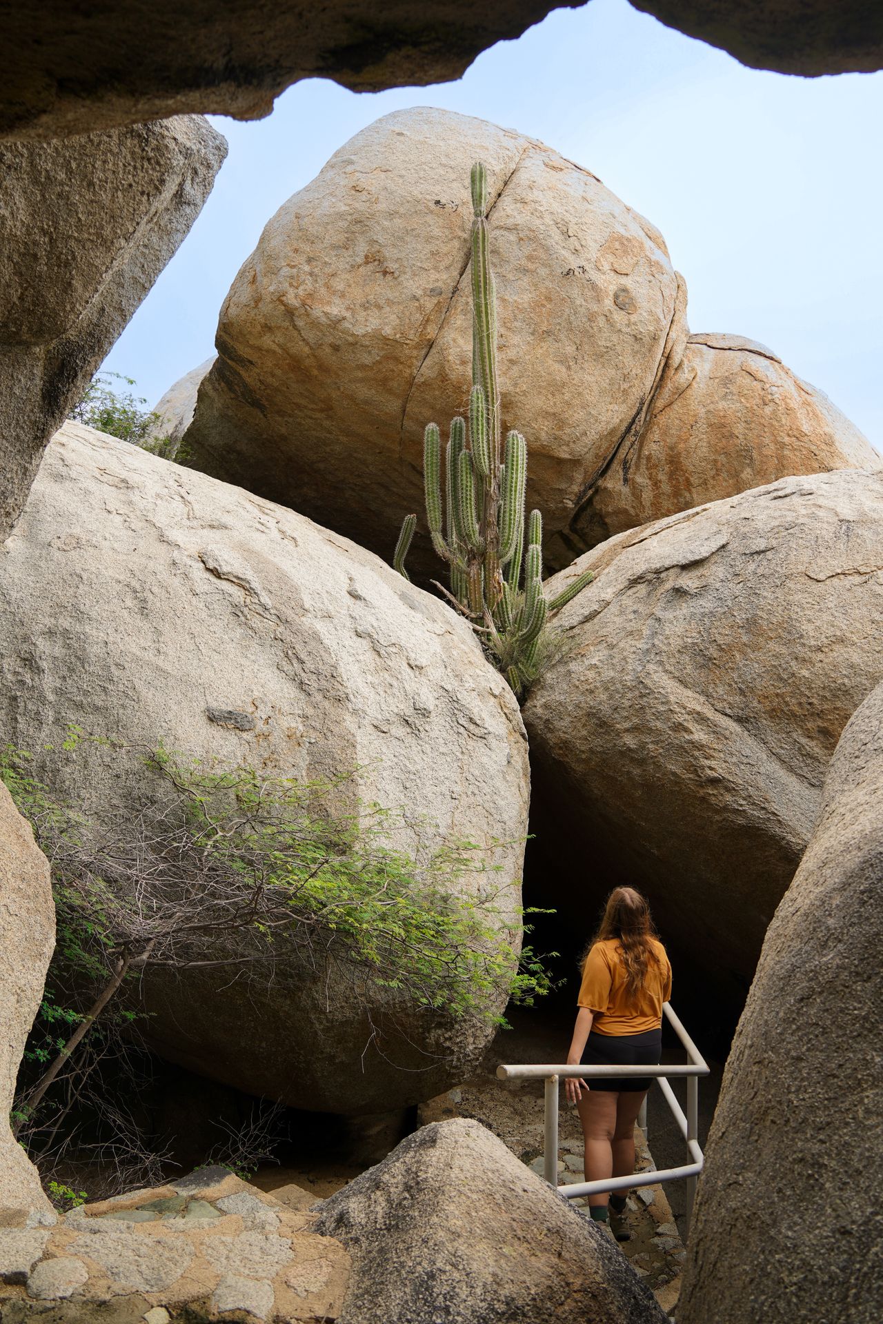 Lydia hiking through boulders at the Ayo Rock Formations