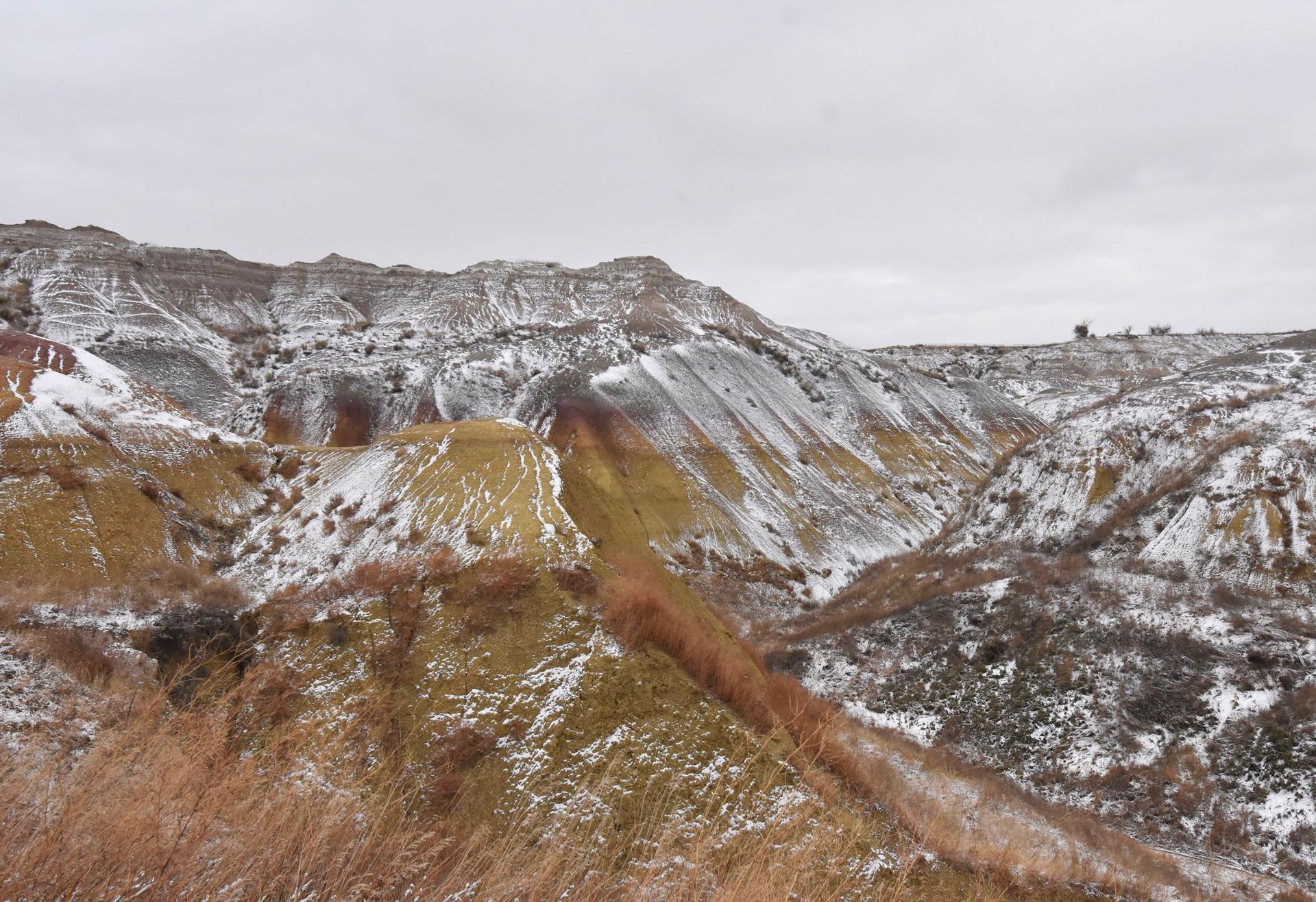 The Yellow Mounds Overlook dusted in snow during winter in Badlands National Park