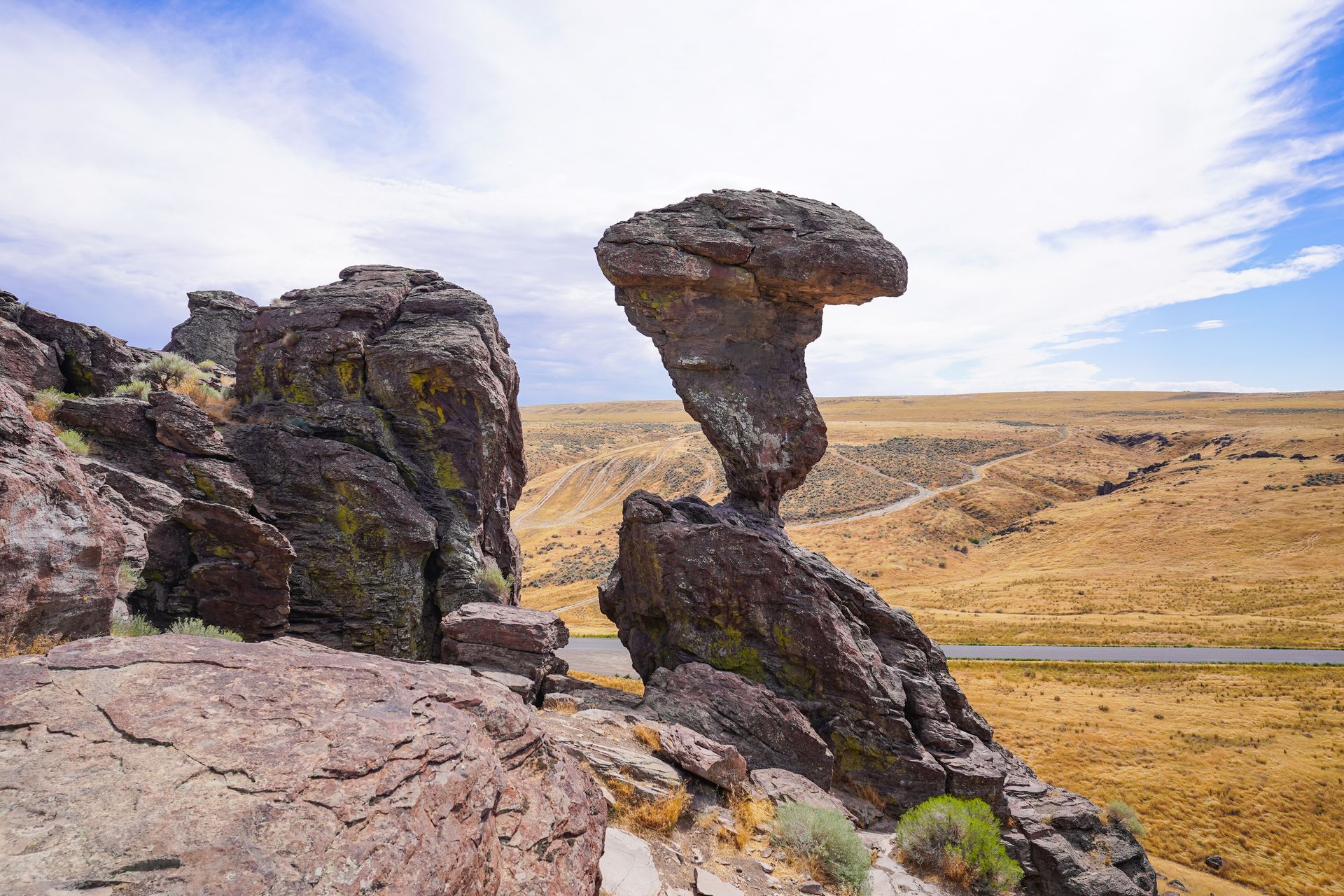 A large rock balancing on a very thin area.