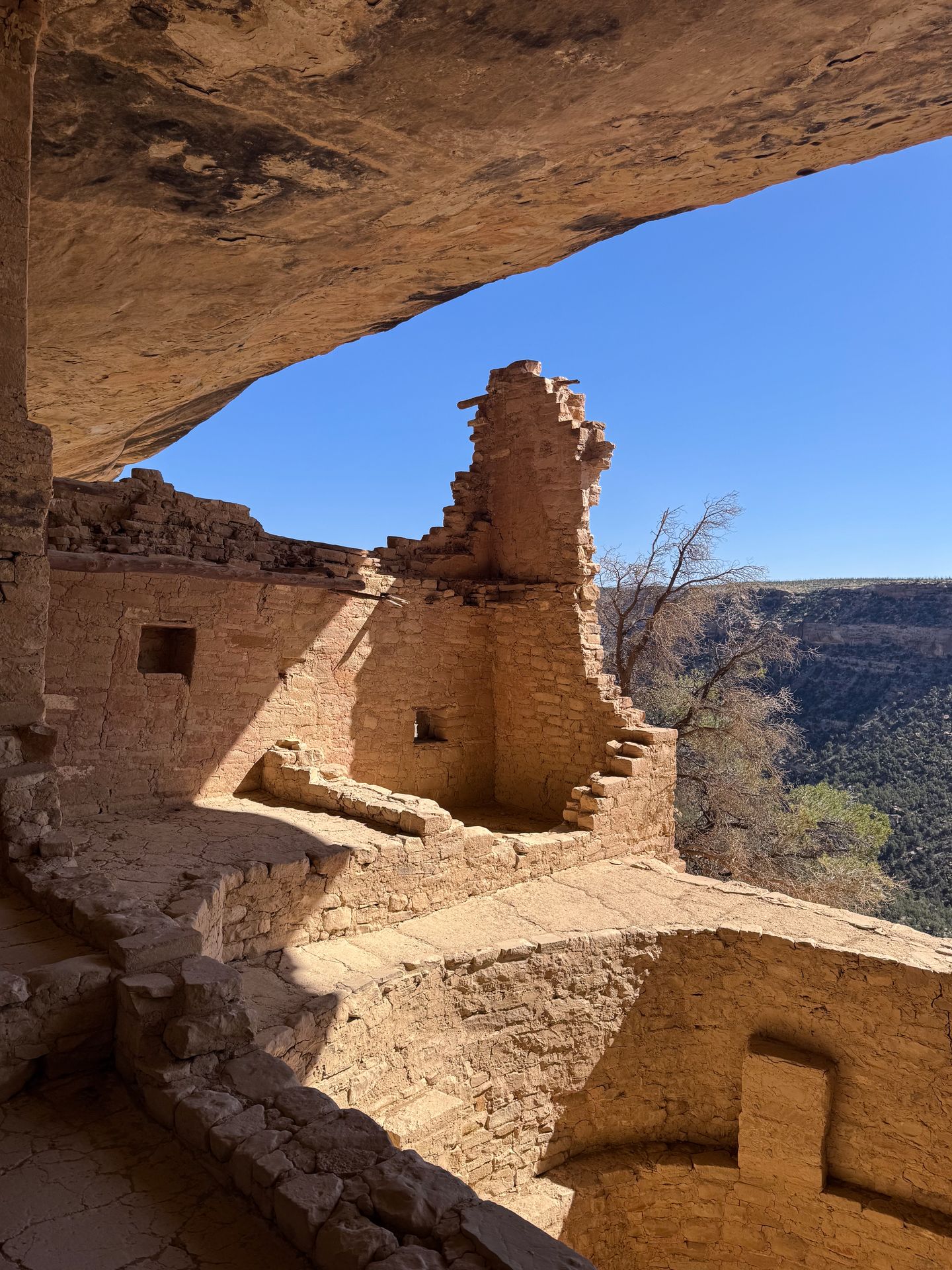 Looking out from inside of Balcony House. You can see a kiva and a tall structure
