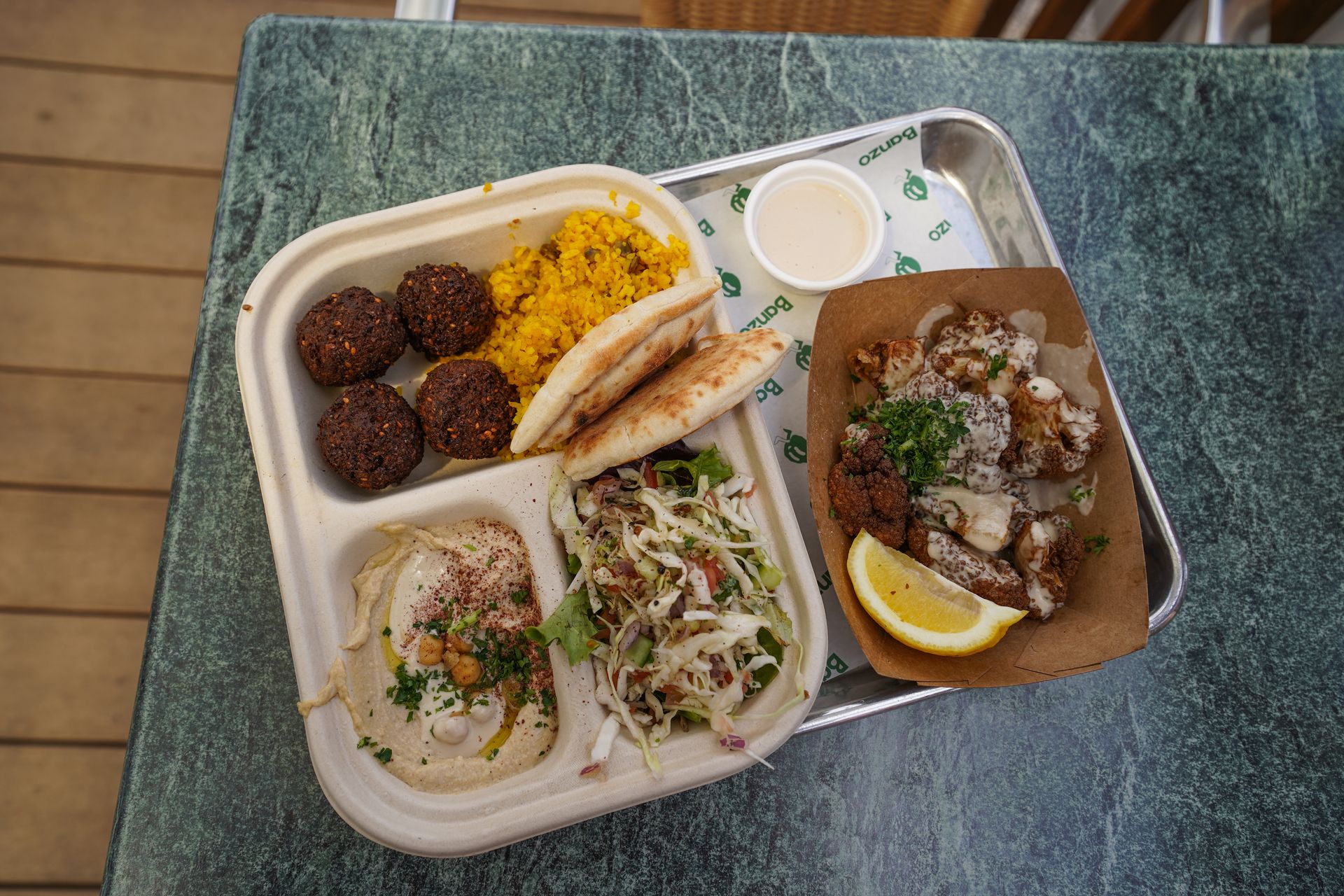 A Mediterranean platter from Banzo that includes falafel, pita bread, hummus, fried cauliflower and salad