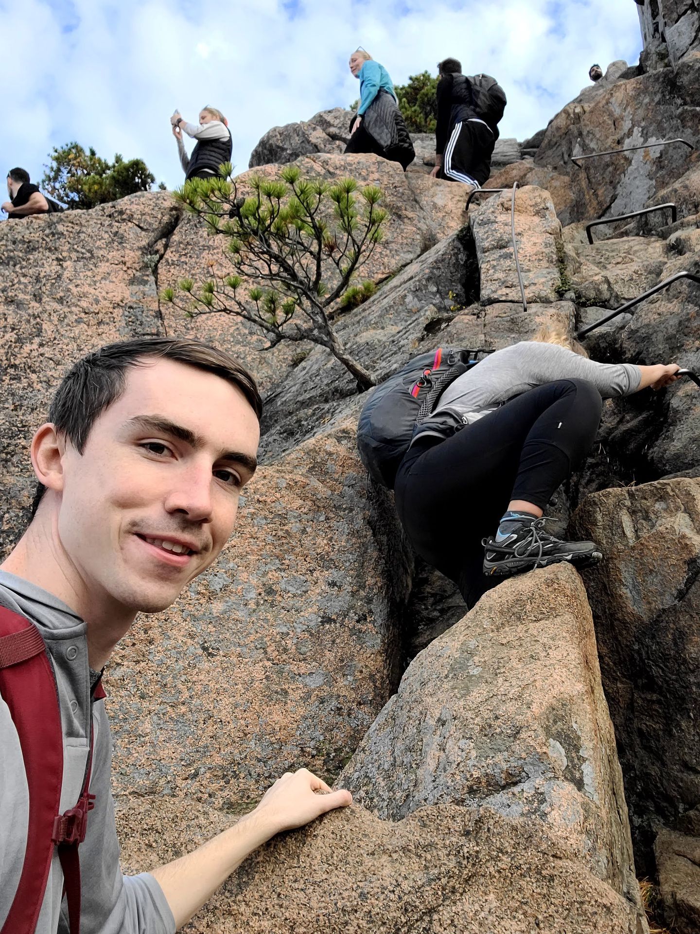 Lydia and Joe climbing up ladders on the Beehive Trail