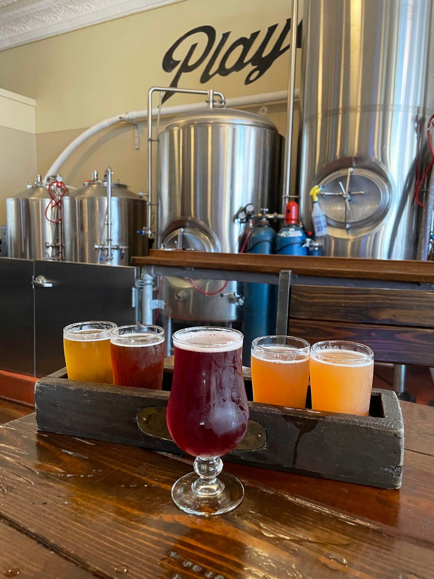 A flight of 5 beers sitting on a table at the Playadina Brewing Company.
