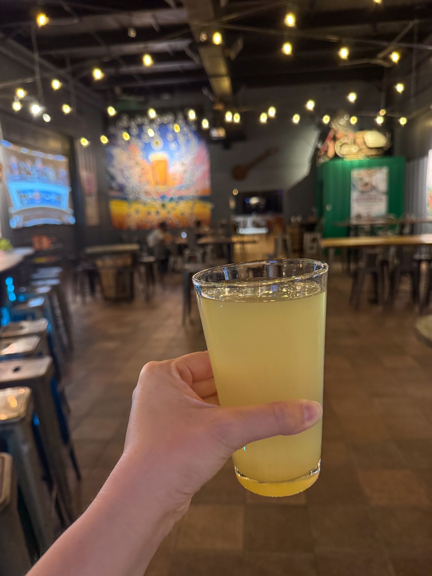 Holding up a pint of beer inside of Freefolk Brewery