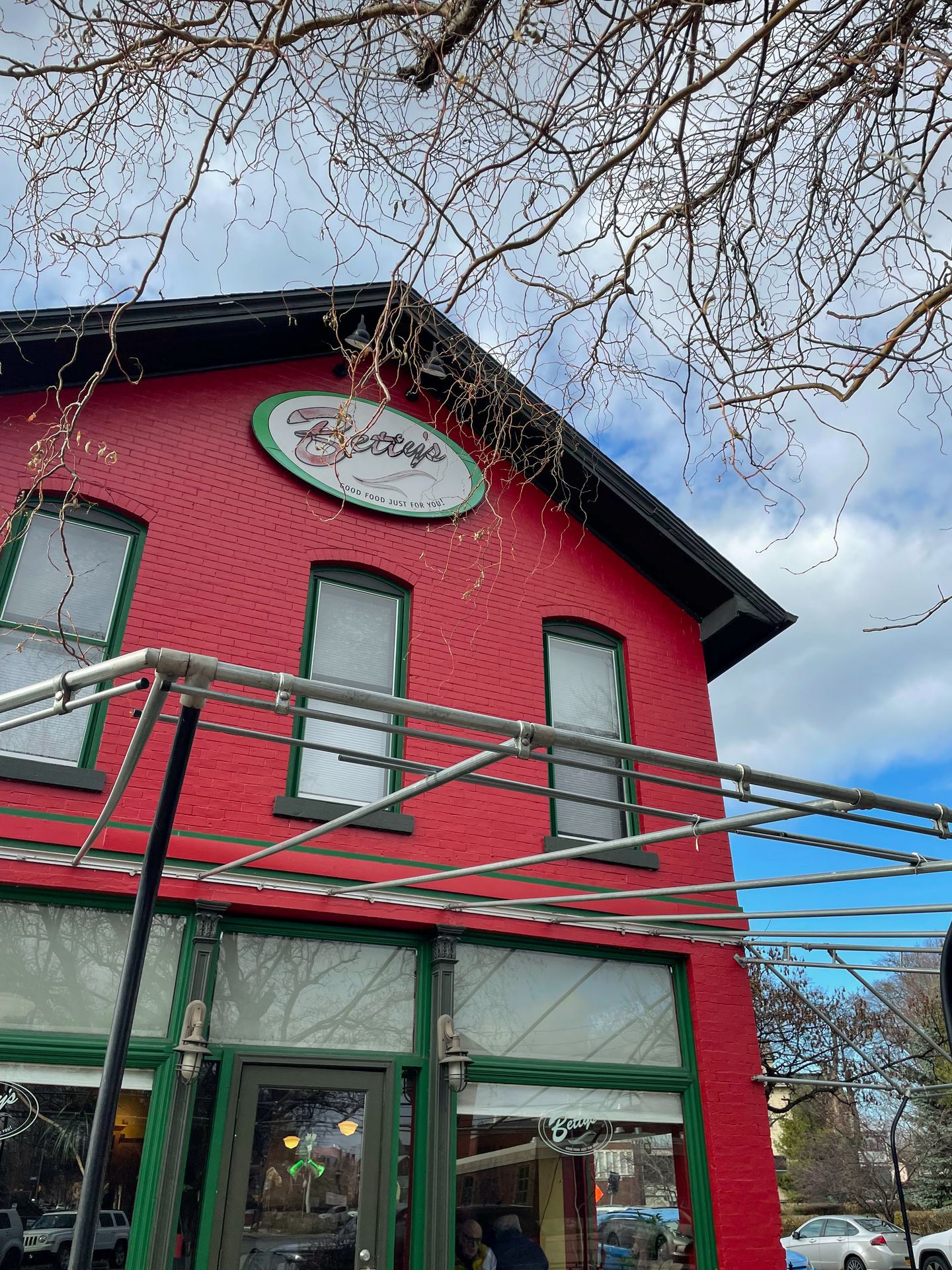 A red building that reads 'Betty's' in an oval near the top of the exterior front.