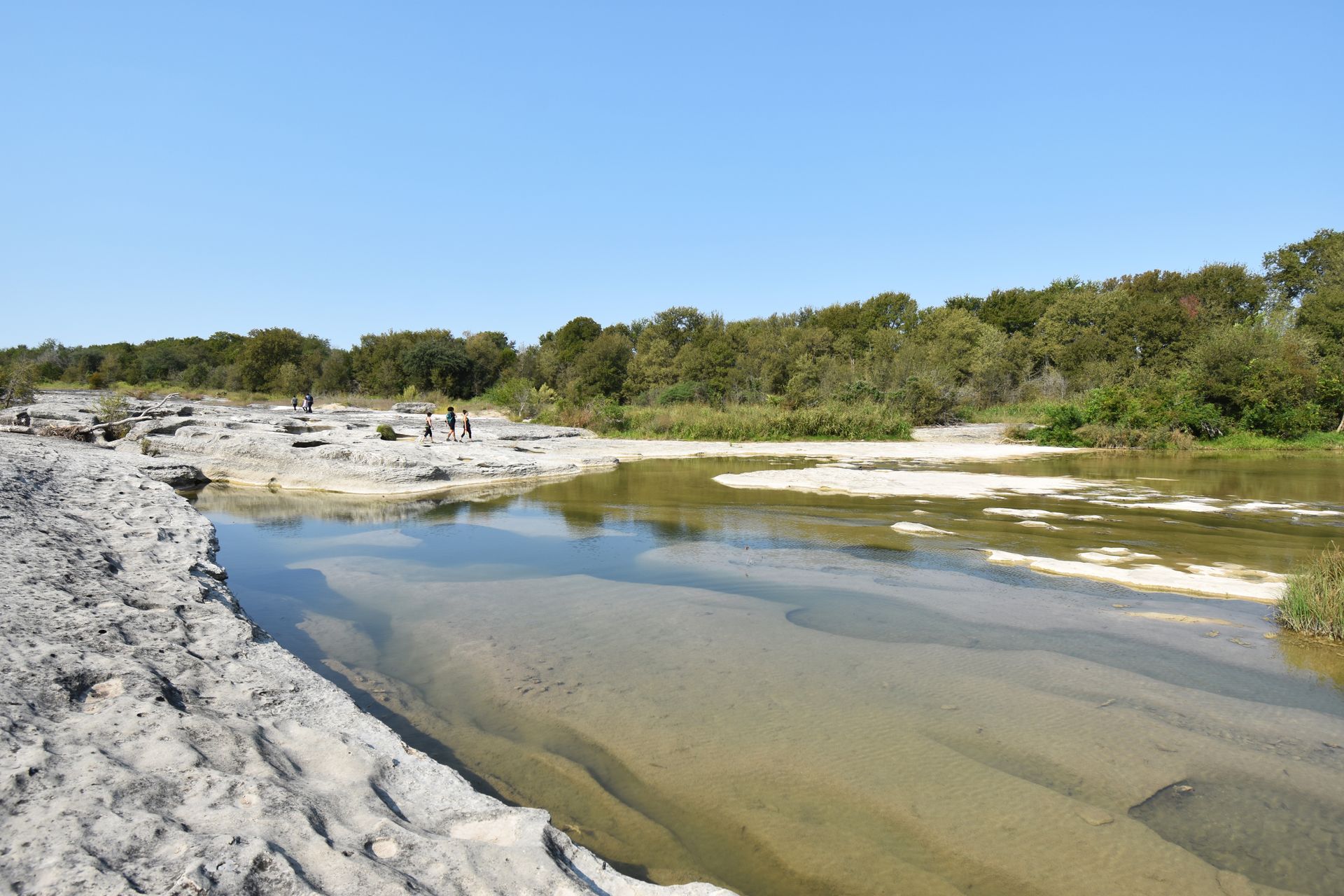 A limestone rock area with water covering a large portion.