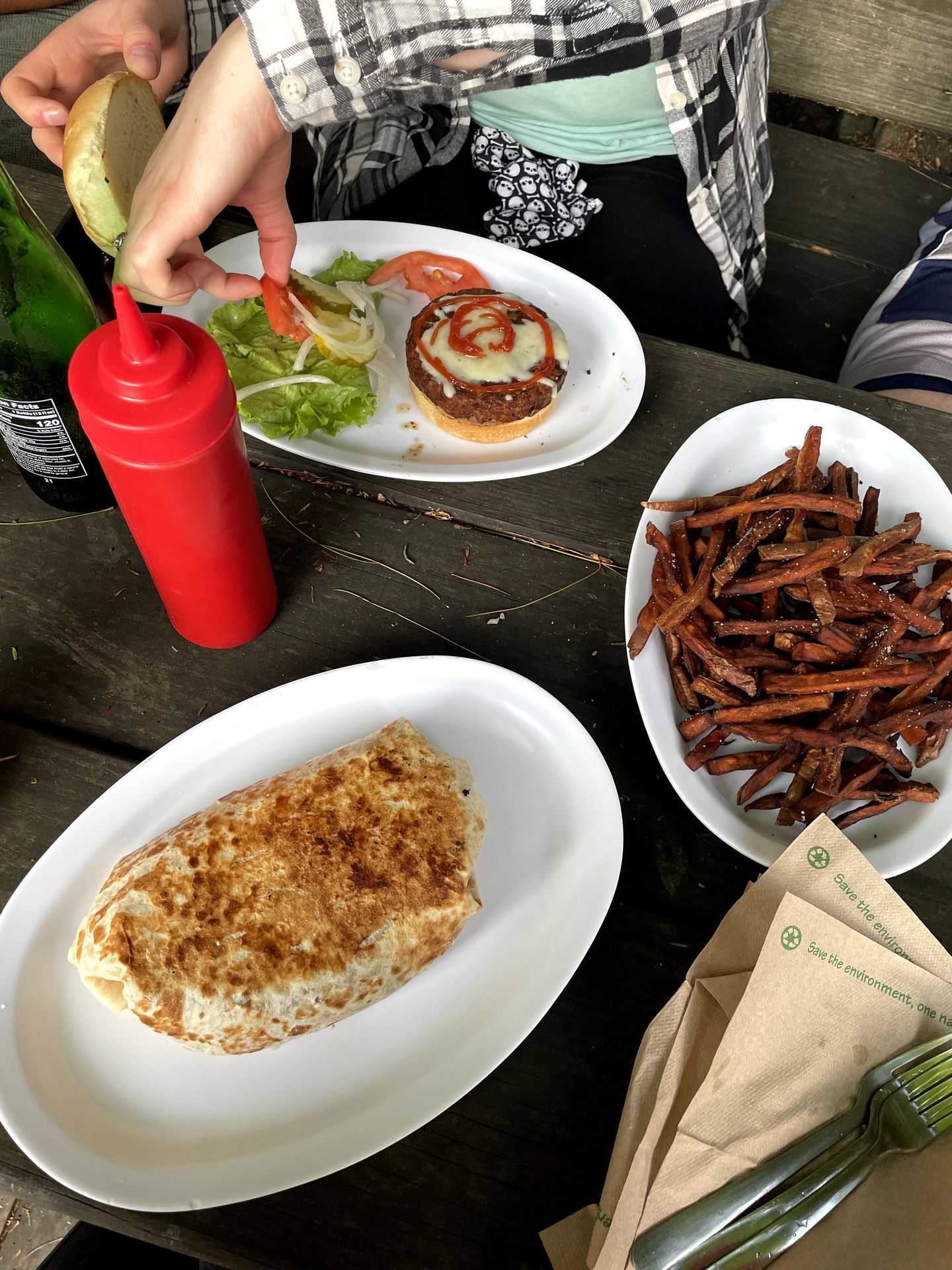 Plates of a burrito, fries and a burger at Red River Rockhouse