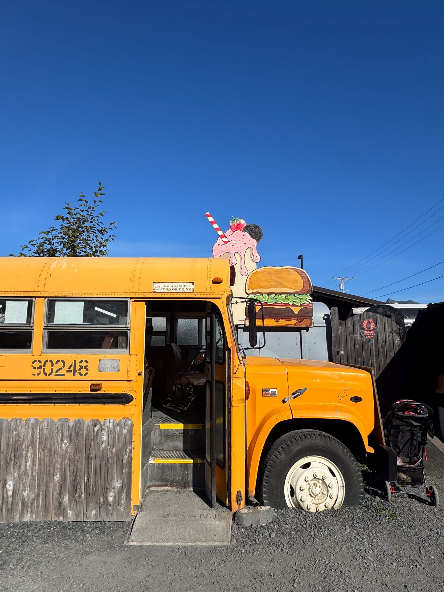 A yellow school bus where you can eat your meal at Red's Burgers