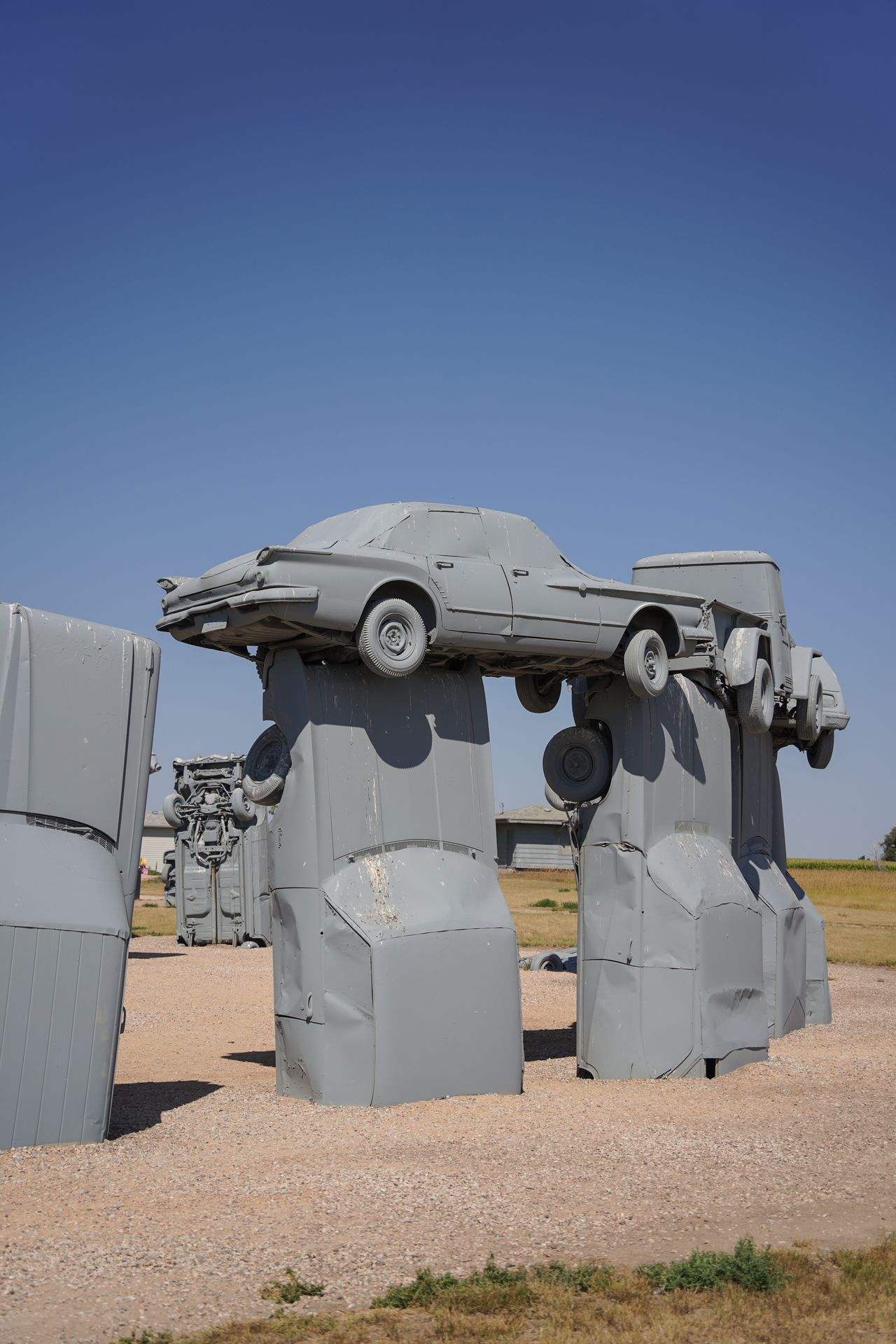 Cars painted gray and stacked on top of each other to resemble the rocks at Stonehenge in England