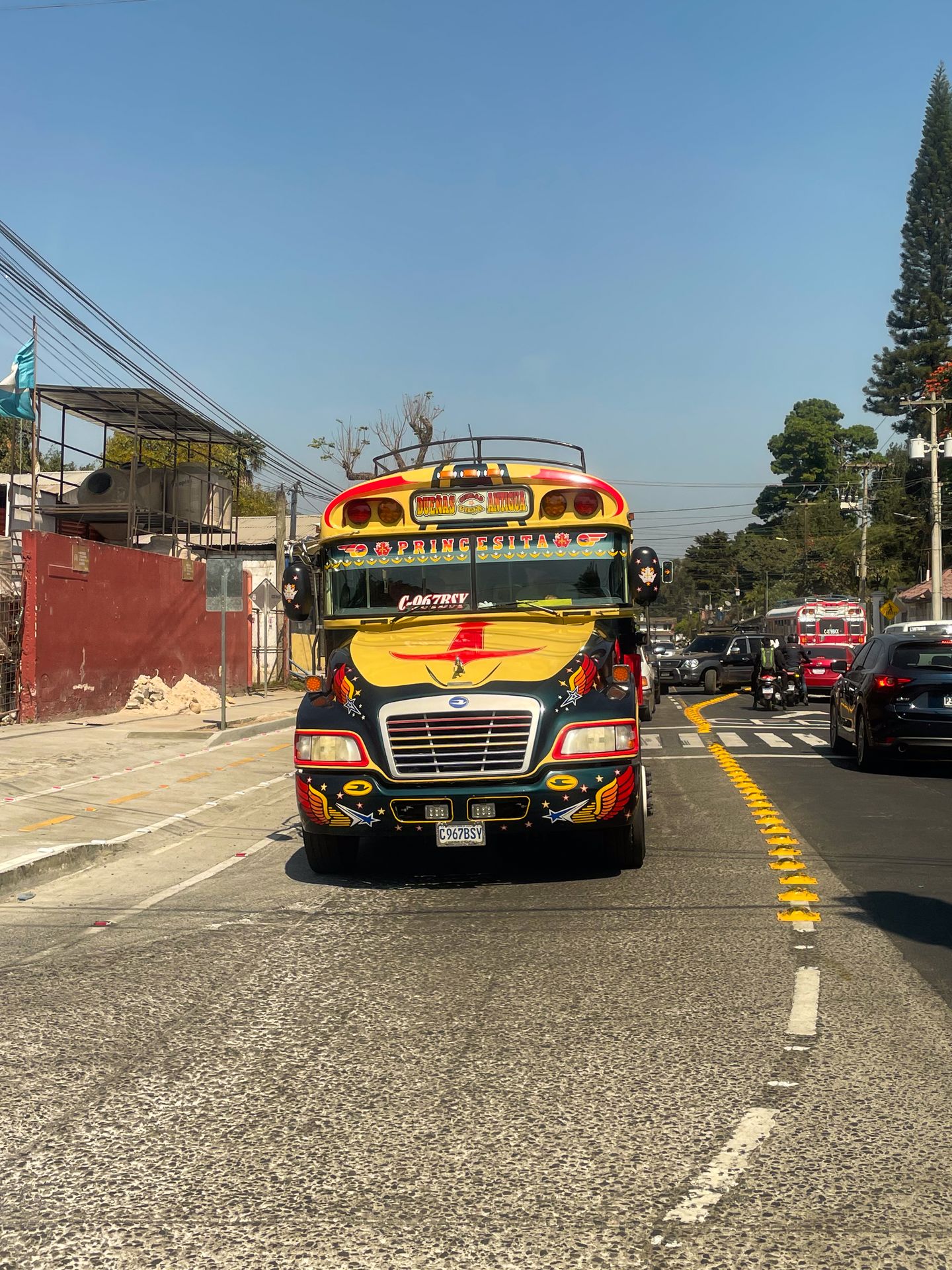 A school bus painted with yellow, red and black patterns