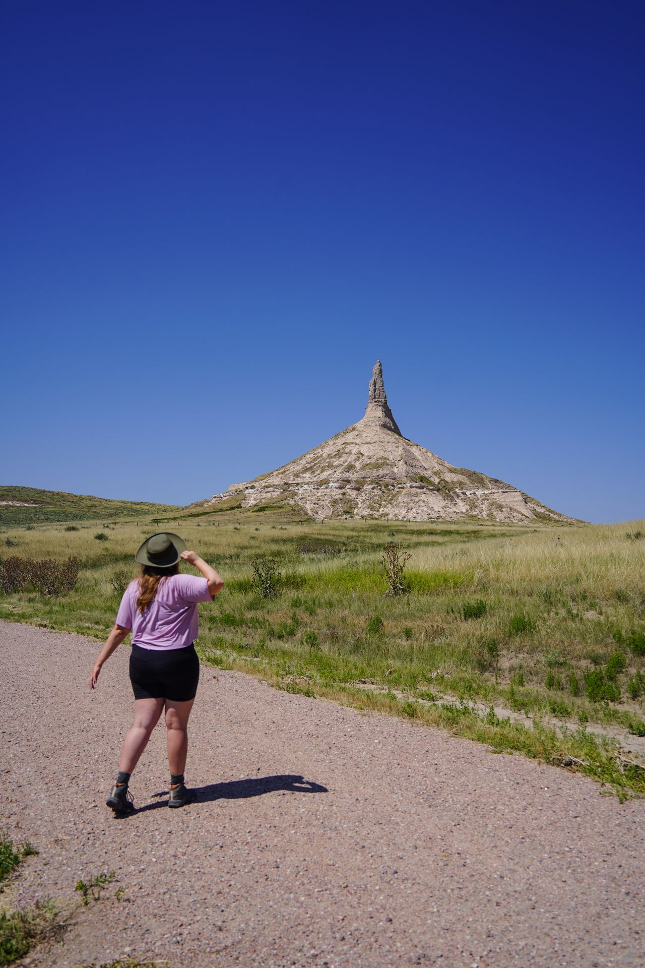 Lydia hiking and looking up at Chimney Rock in Nebraska