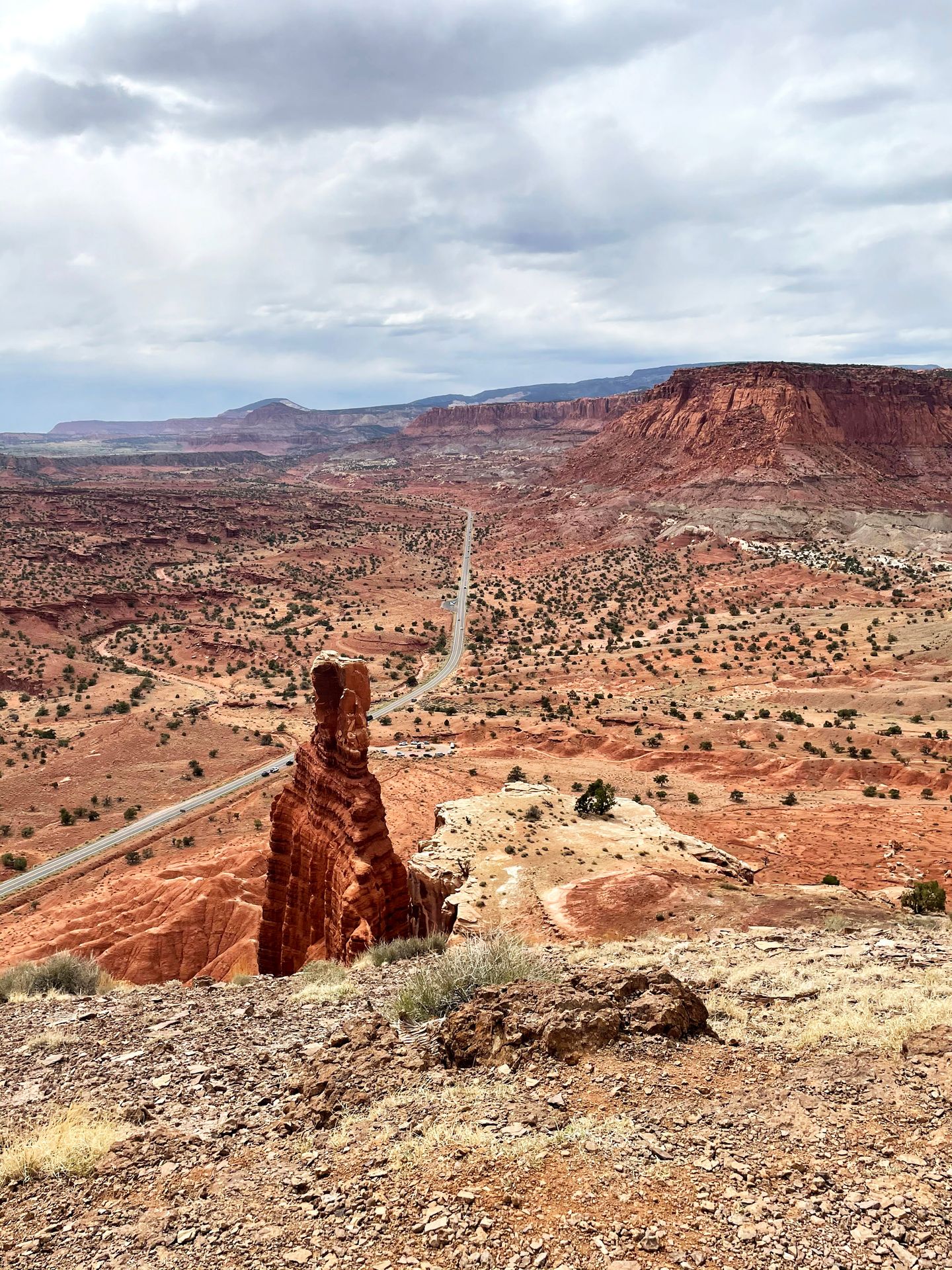 Looking down at the Chimney Rock with a view of the valley and the road below it.
