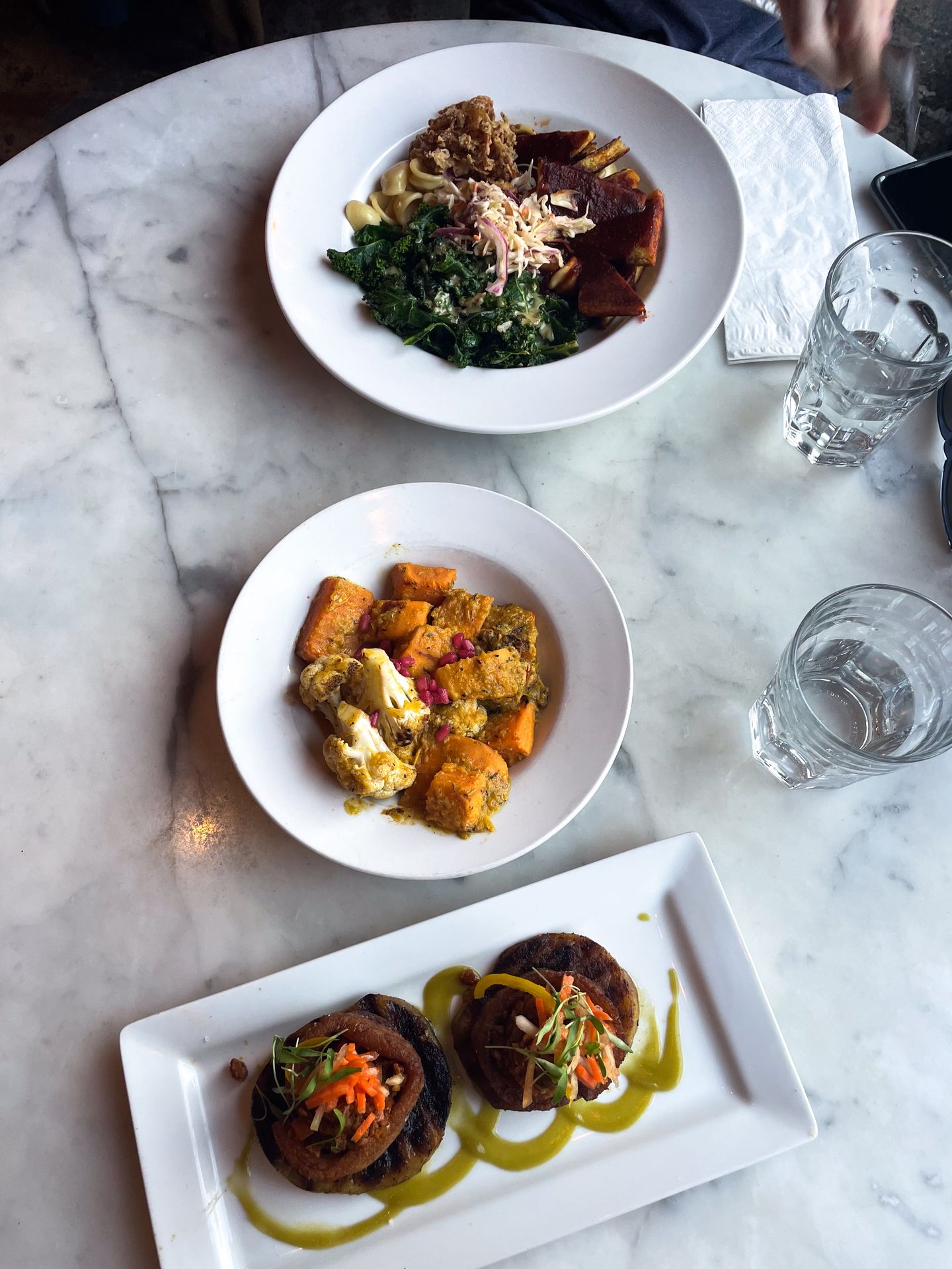 3 Plates of food on a white table at City 'O City