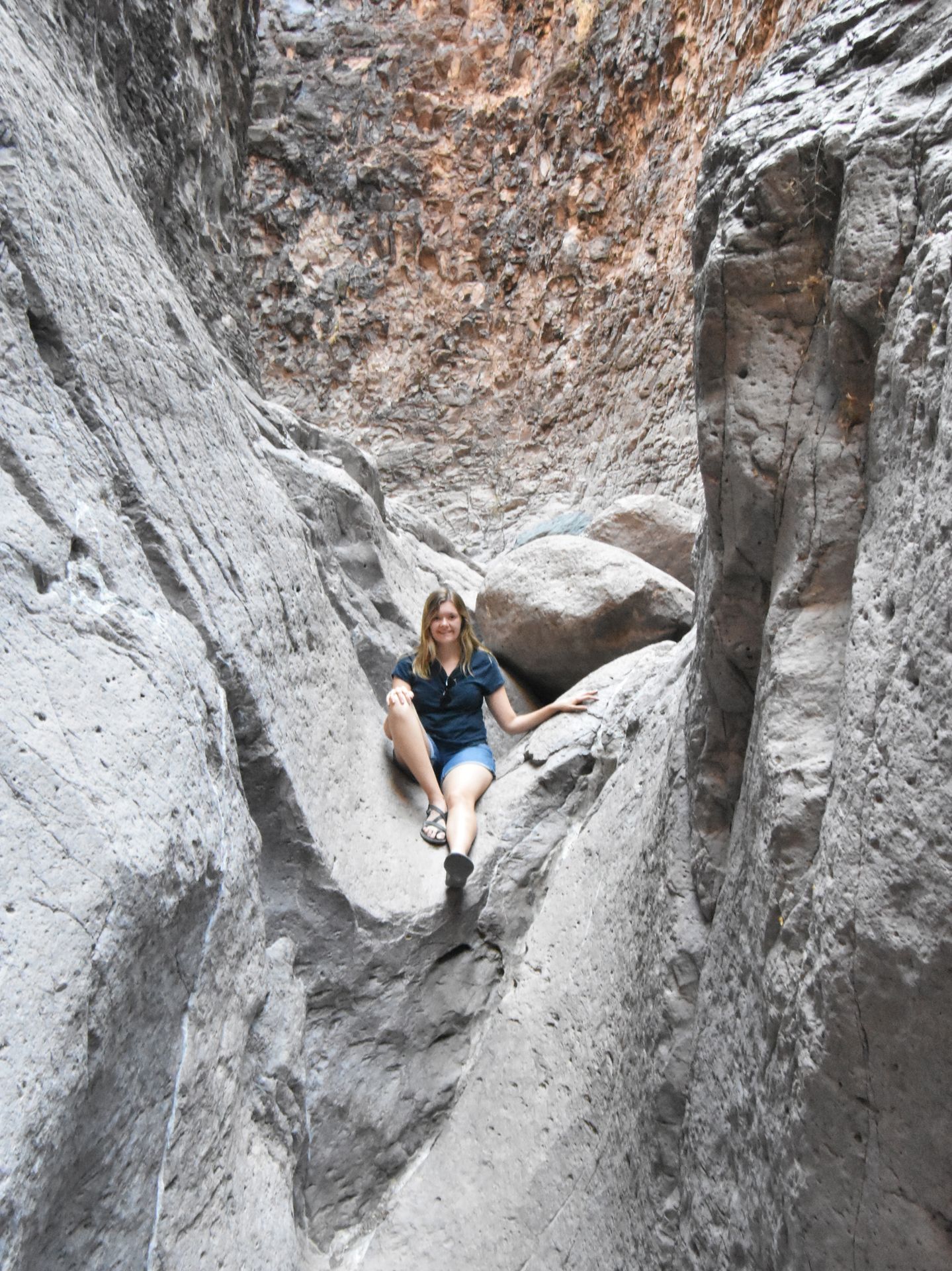 Lydia sitting on some rocks on the Closed Canyon trail in Big Bend Ranch State Park.