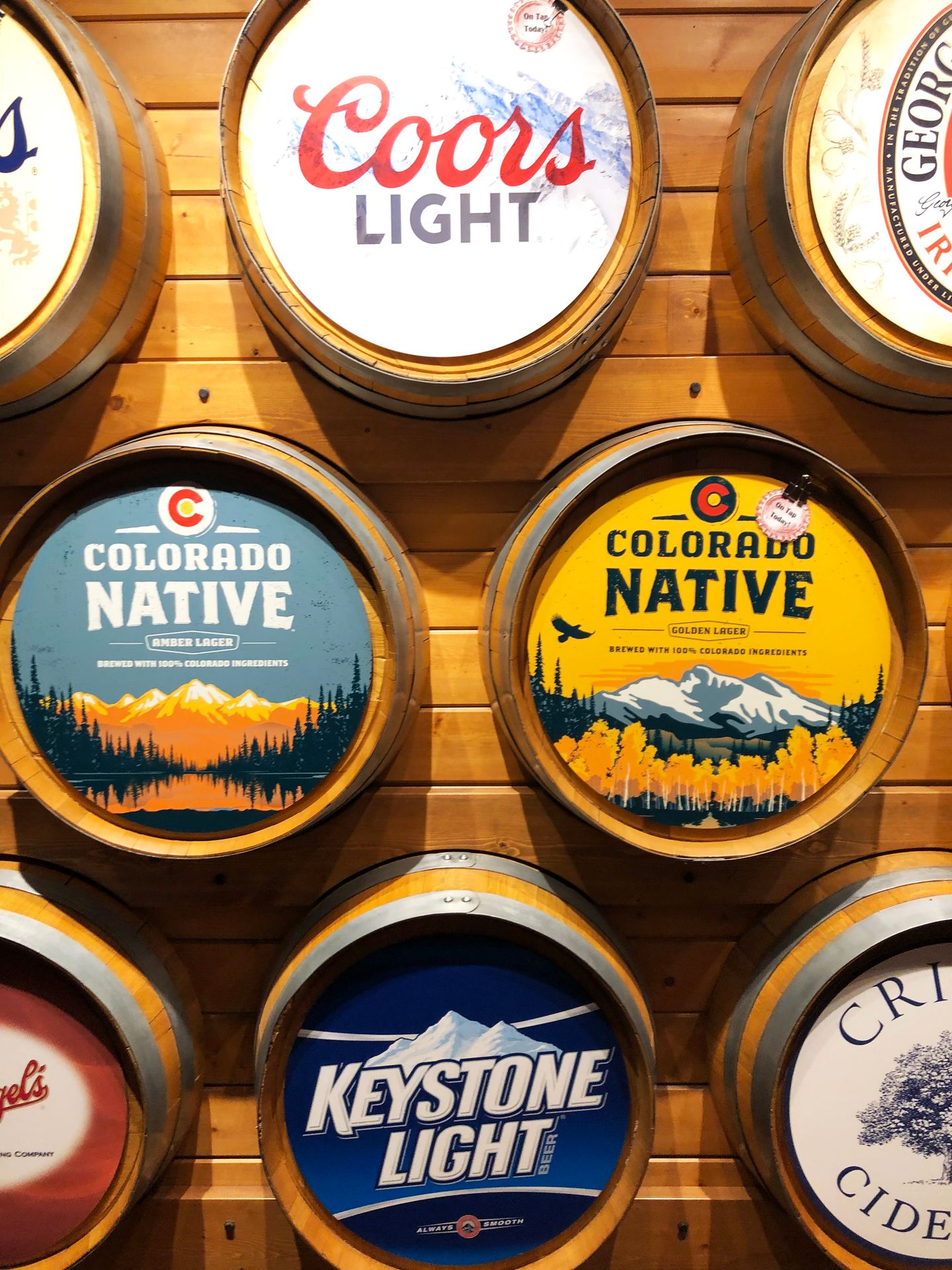 A wall full of barrels at the Coor's Brewery. The barrels are labeled with different Coor's brands, such as Keystone Light and Colorado Native.