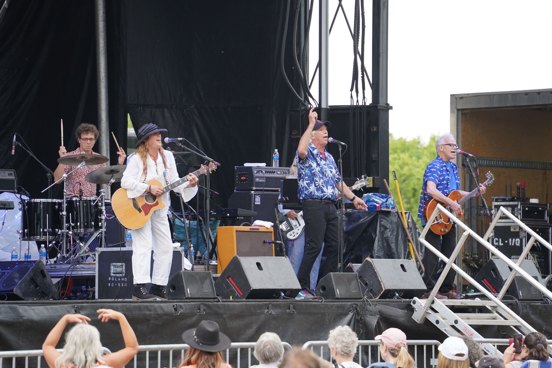 3 people (2 men and 1 woman_, playing music on stage at the Granite City Days Block Party