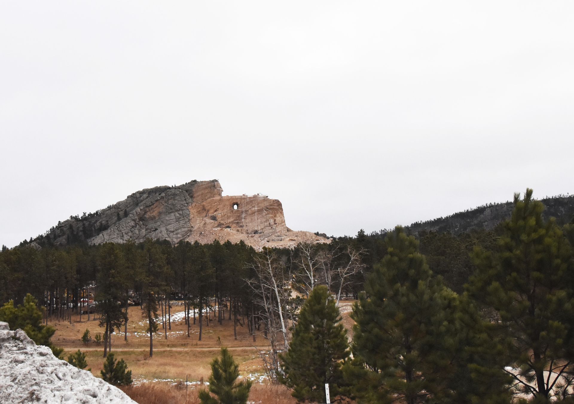 A rock carving of an Oglala Lakota warrior carved into a huge rock face.