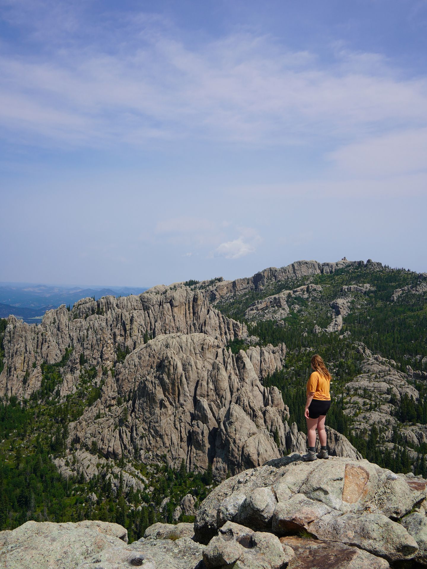 Lydia looking out a view of rock formations while hiking in Custer State Park
