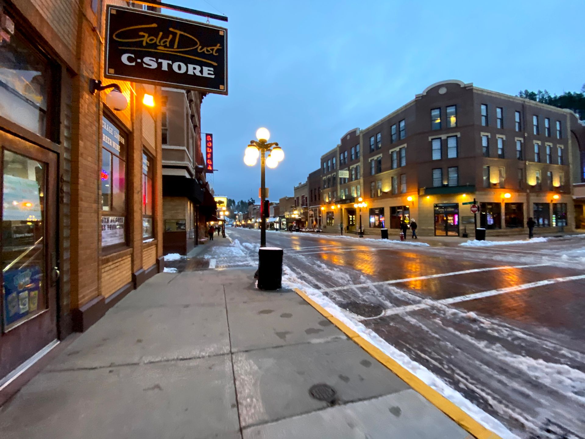 A street in the city of Deadwood. A sign reads 'Gold Dust C-Store'