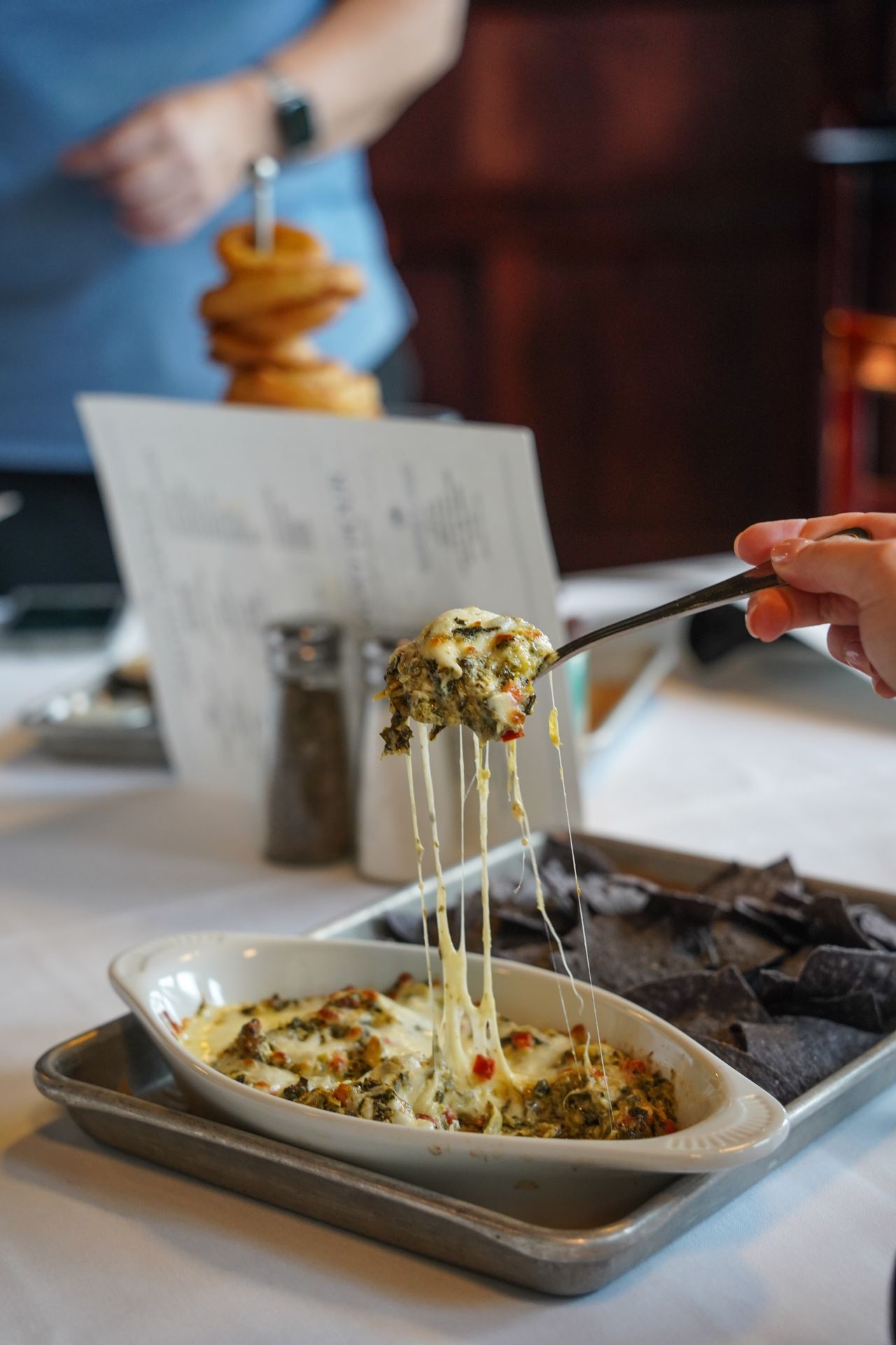 Serving spinach artichoke dip at Black Cow Fat Pig Pub