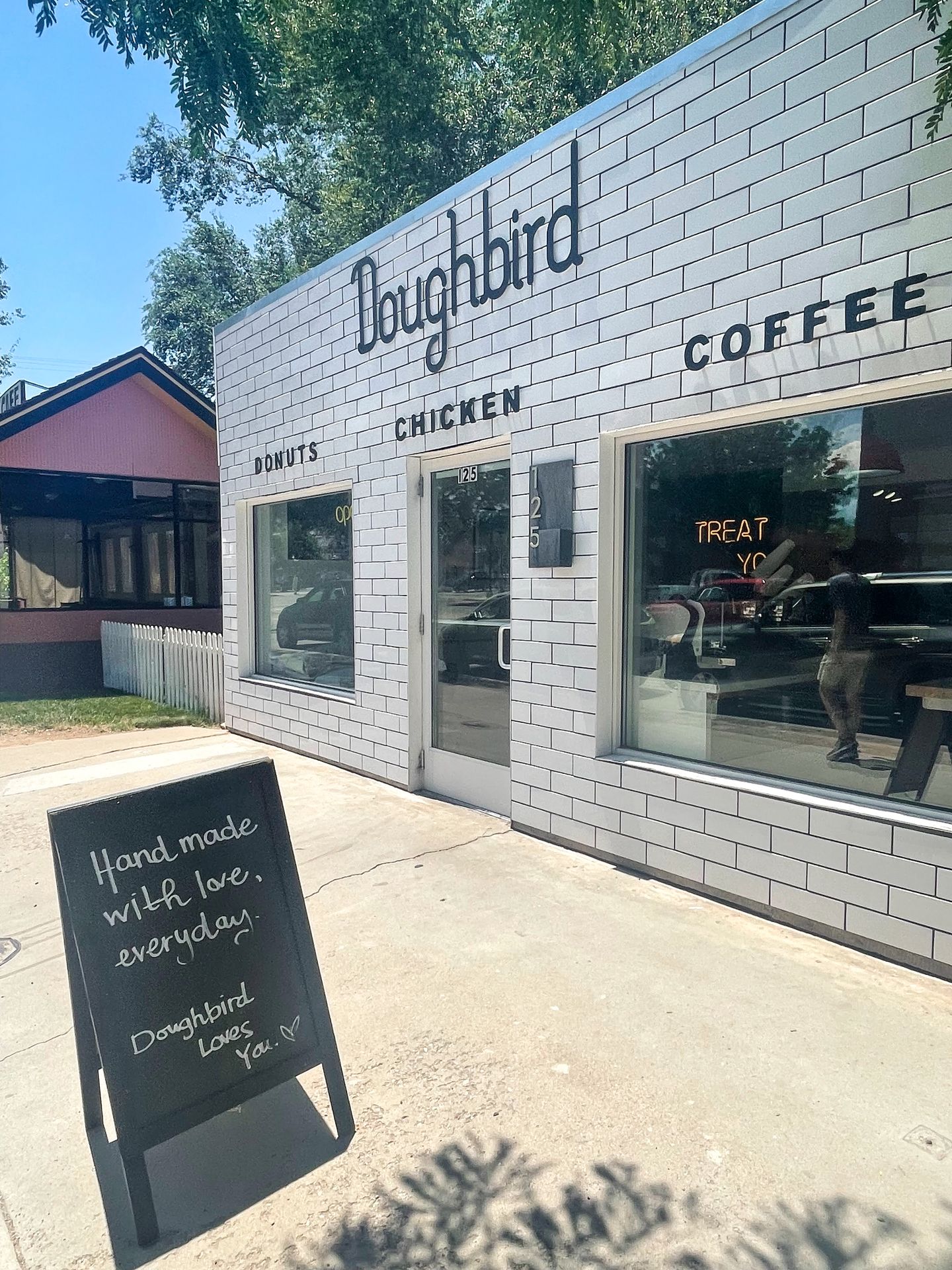 The exteior of Doughbird, a building with white tiles