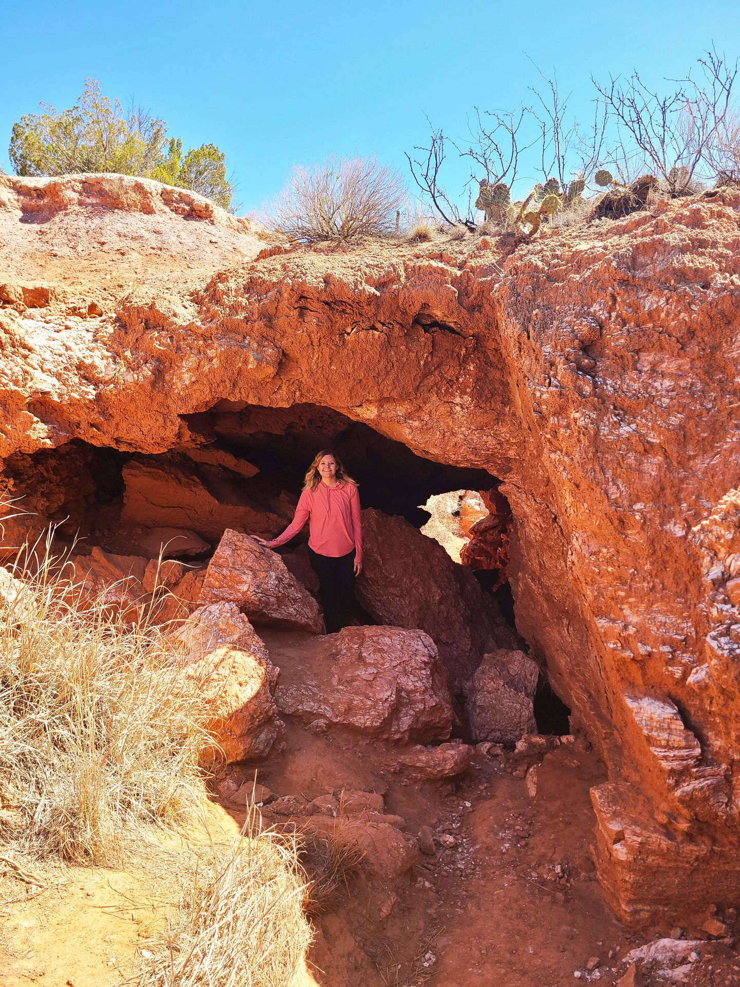 Lydia standing inside of a cave under the Eagel Point trail.