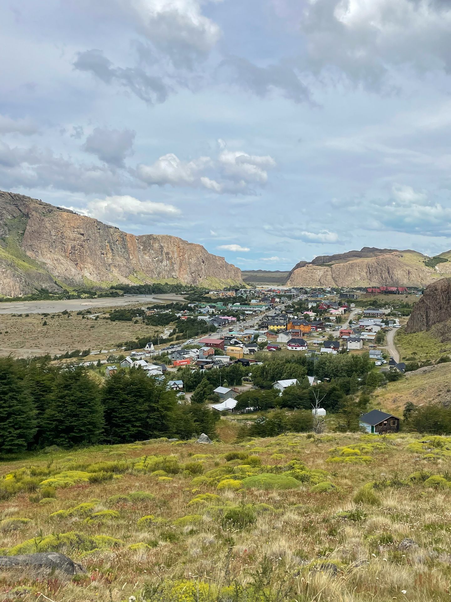 A small city tucked in valley between mountains.