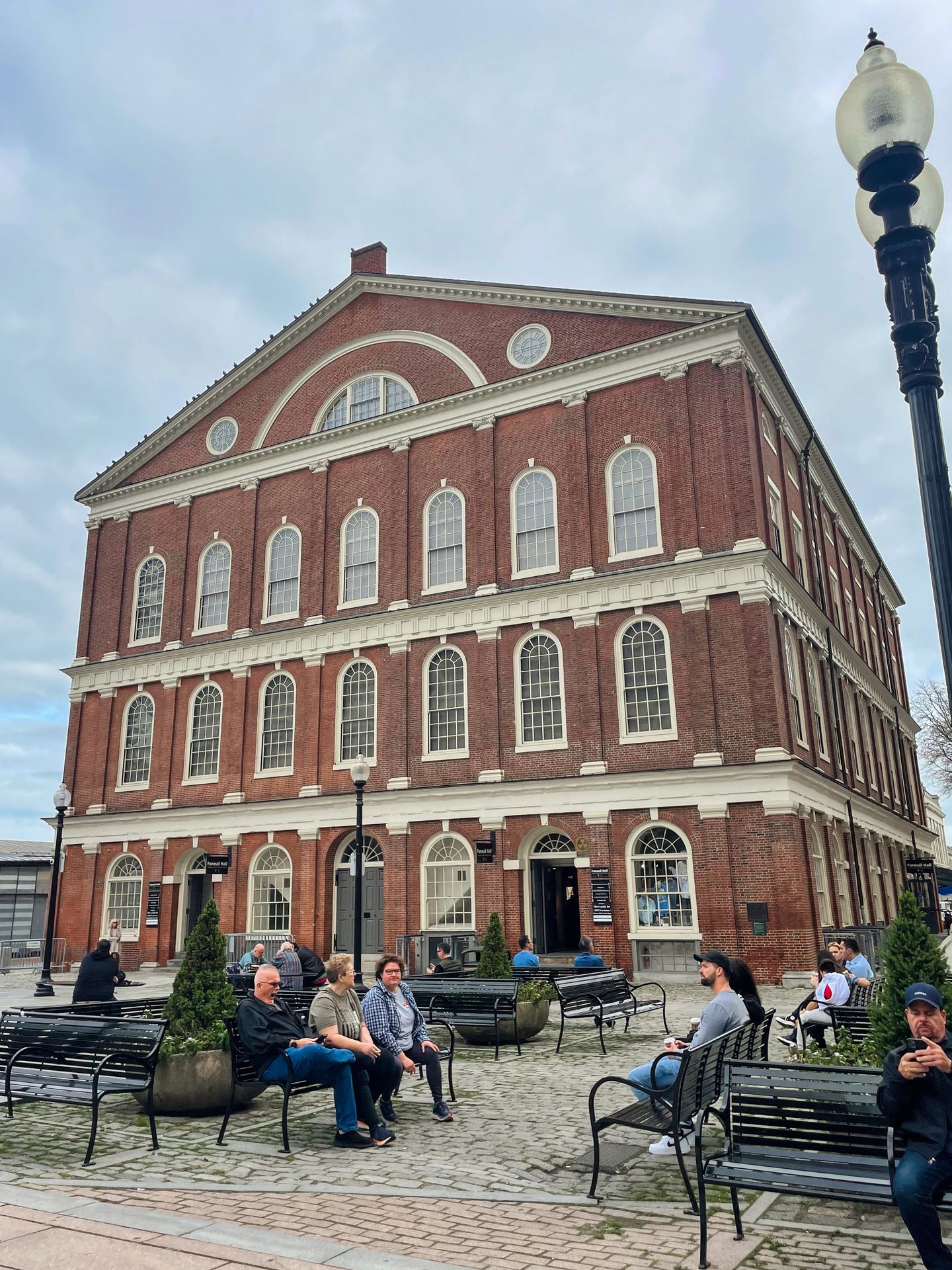 A large brick building with benches in front