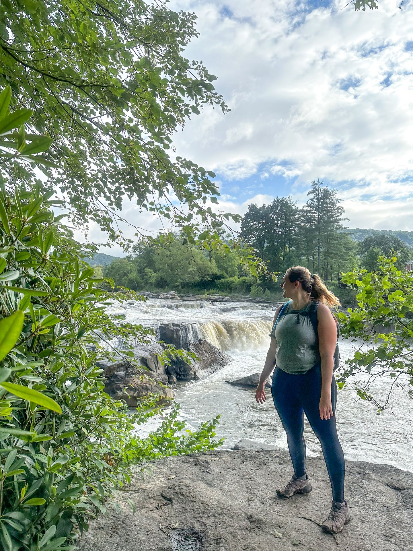 Lydia looking at a waterfall while hiking the Ferncliff Trail in Ohiopyle State Park