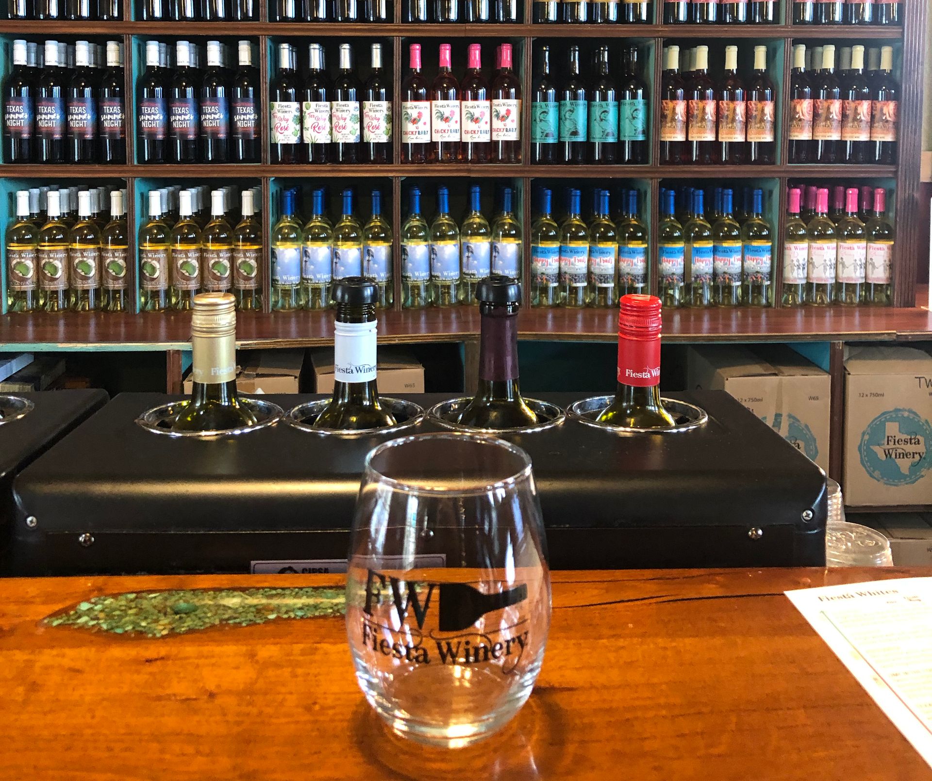 A wine glass sitting at a bar at the Fiesta Winery.