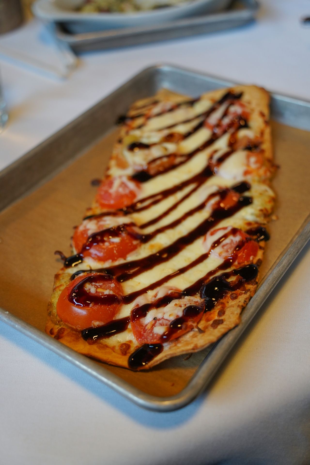 A flatbread with balsamic glaze from Black Cow Fat Pig Pub