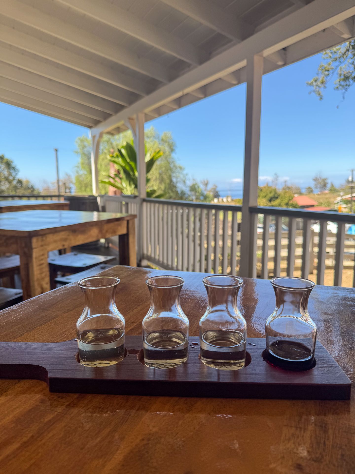 A flight of 4 different wines on the patio of MauiWine