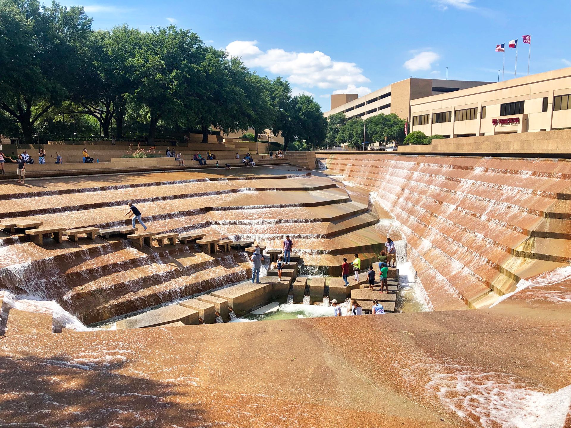 Looking down a staircase area with several people down inside the water gardens at the Fort Worth Water Gardens.