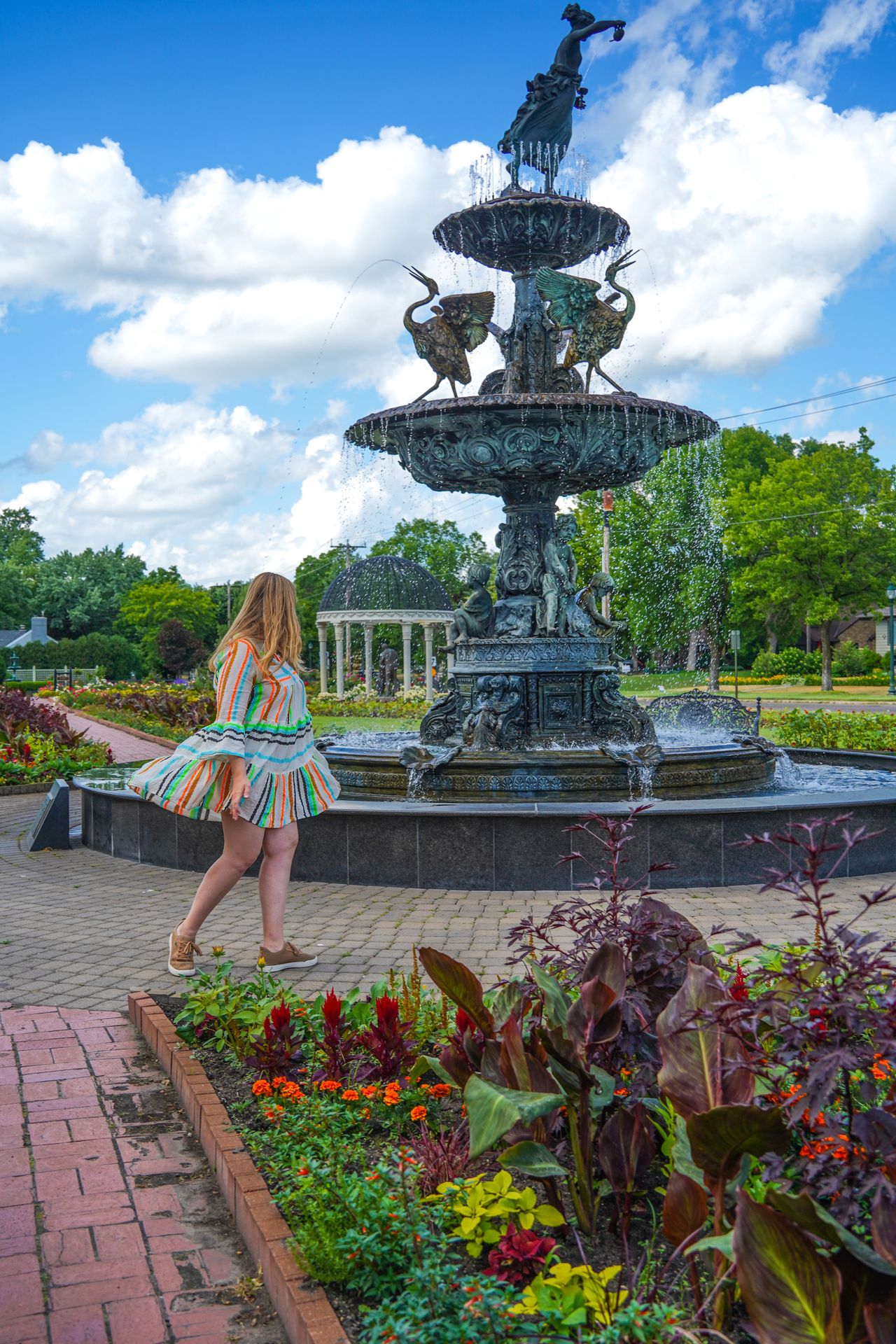 Lydia walking near a fountain at Munsinger Gardens