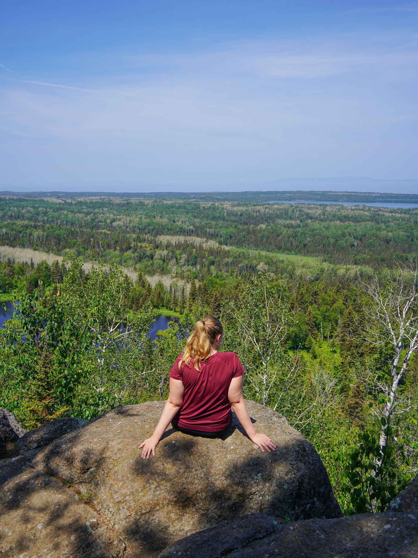 Lydia sitting on a rock and admiring the views from Mount Franklin