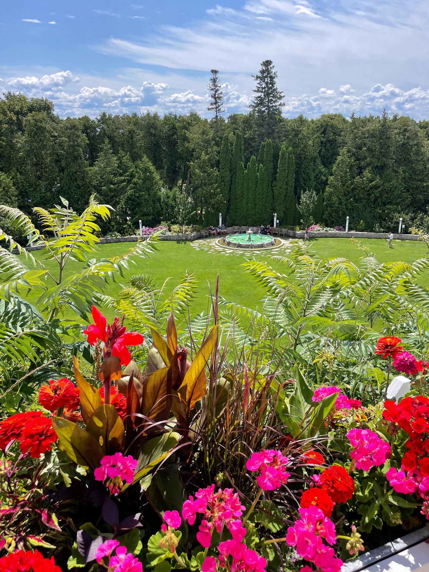 Red and pink flowers in front of the park next to Grand Hotel.